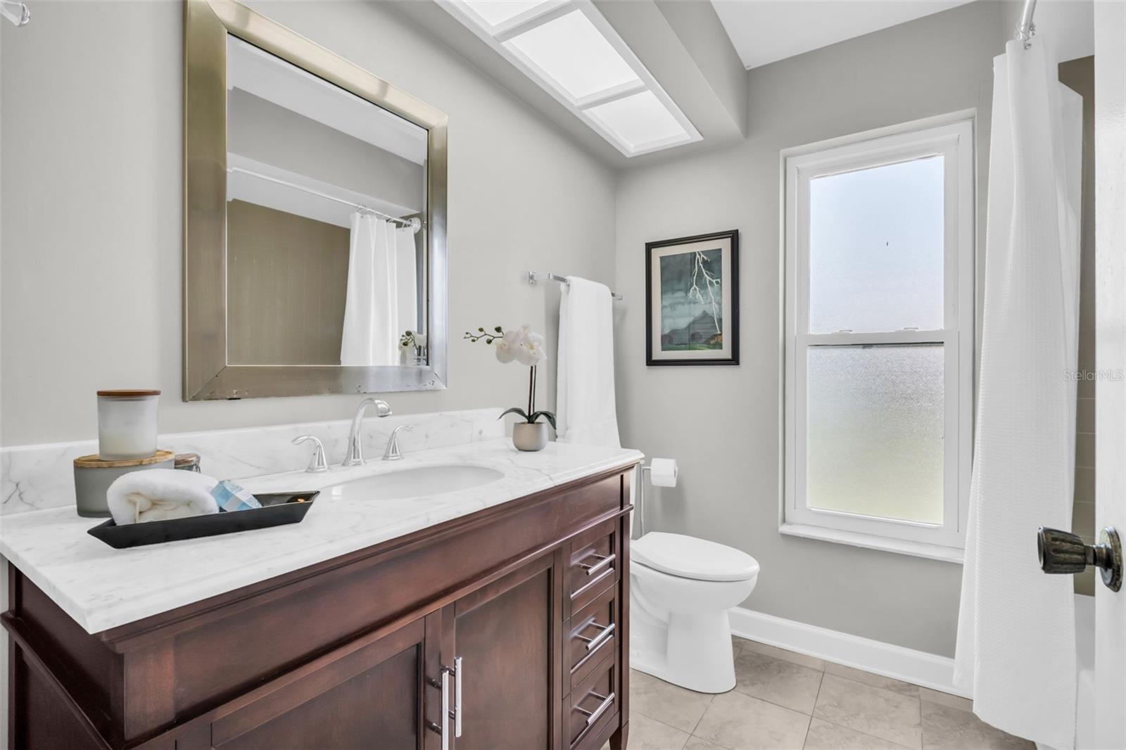 Beautifully updated hall bath with newer stone top vanity~