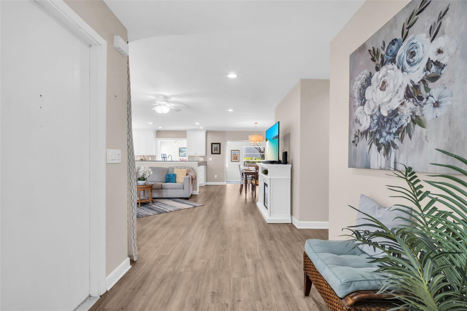 Welcoming front entry with newer luxury vinyl plank flooring and fr4eshly painted interior~