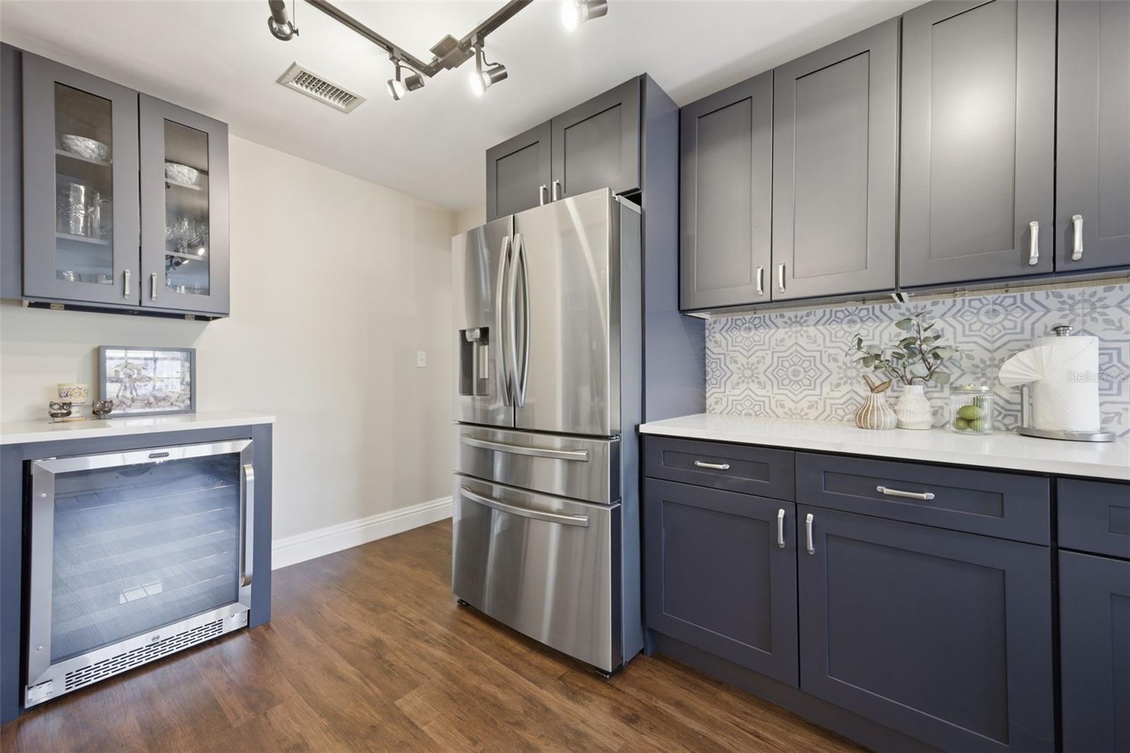 Kitchen with wine refrigerator.