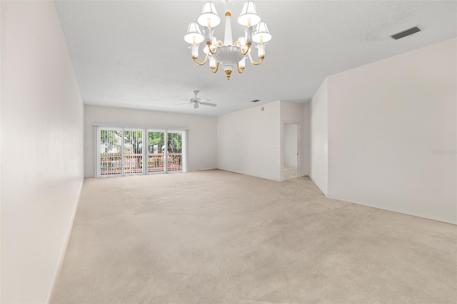 Dedicated dining area positioned adjacent to the kitchen and breakfast bar, ideal for both casual meals and hosting. Light-filled living space with sliding glass doors leading to the private balcony, extending the living area outdoors.