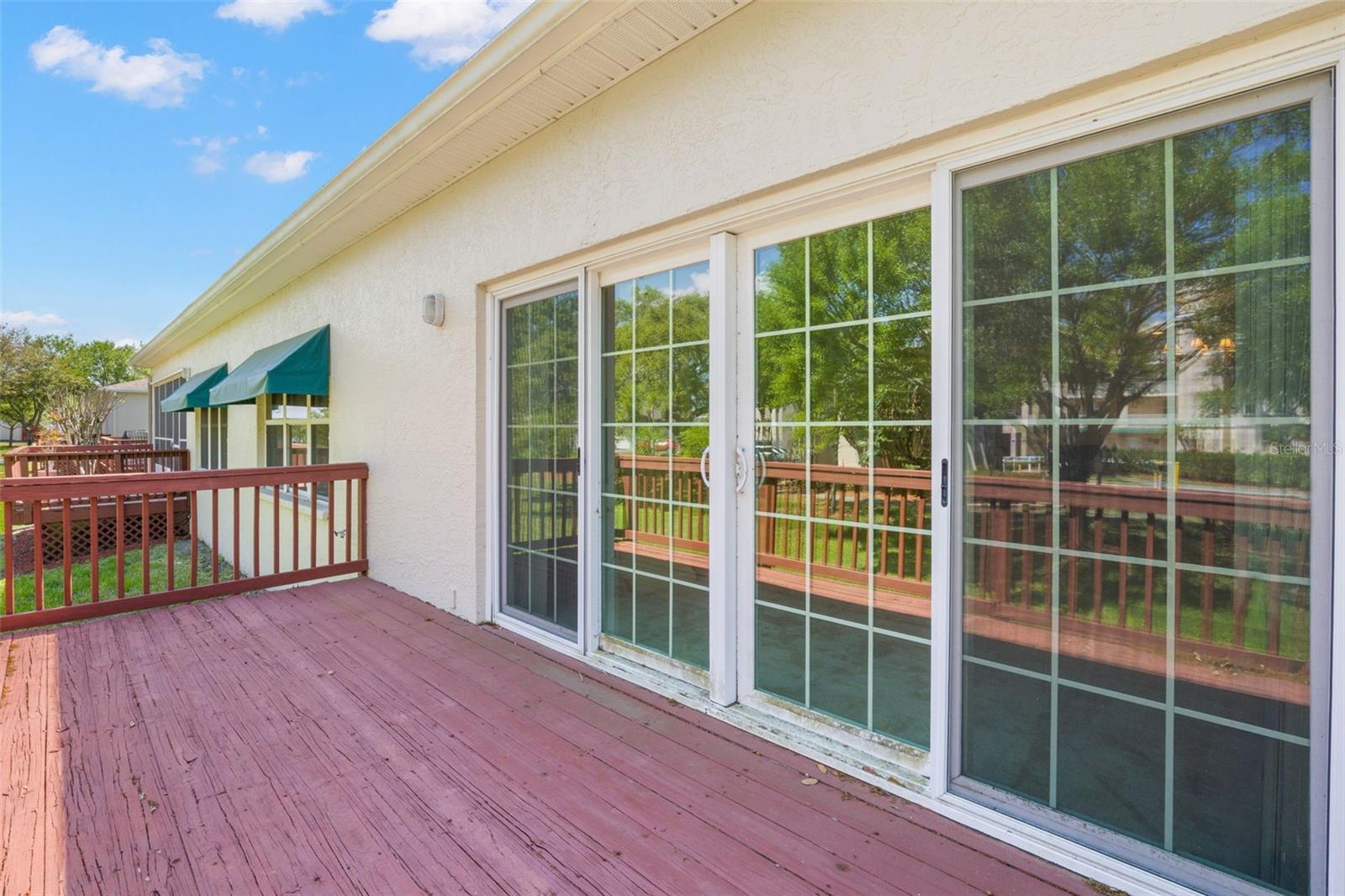 Spacious rear deck with direct access from the living room, offering a generous outdoor area for seating, dining, or creating your own outdoor retreat.