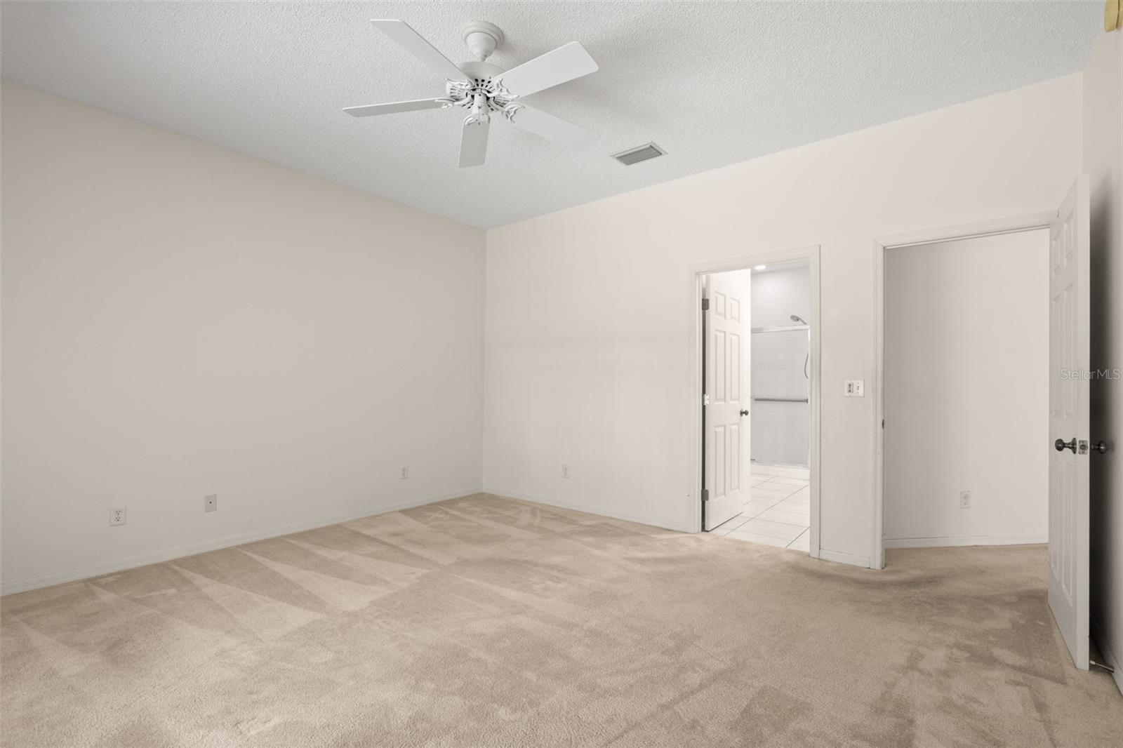 Comfortable primary bedroom with direct access to the ensuite bathroom and walk-in closet, offering a practical and well-connected layout.