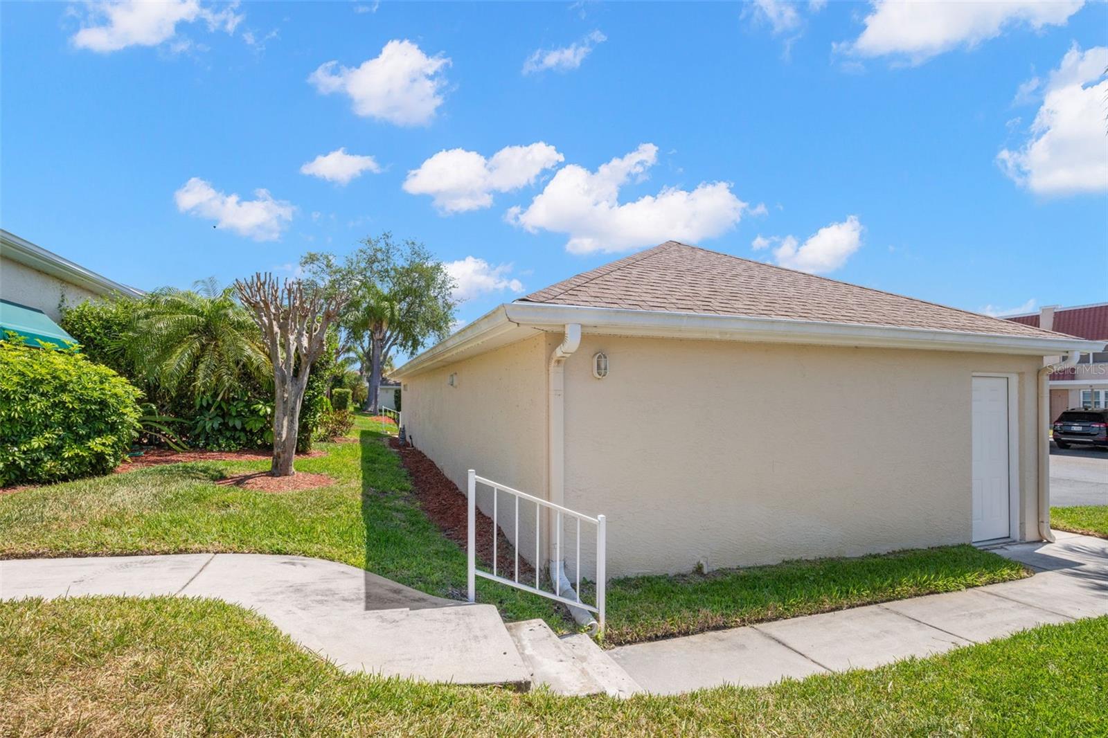 Front sidewalk with entry to detached garage.