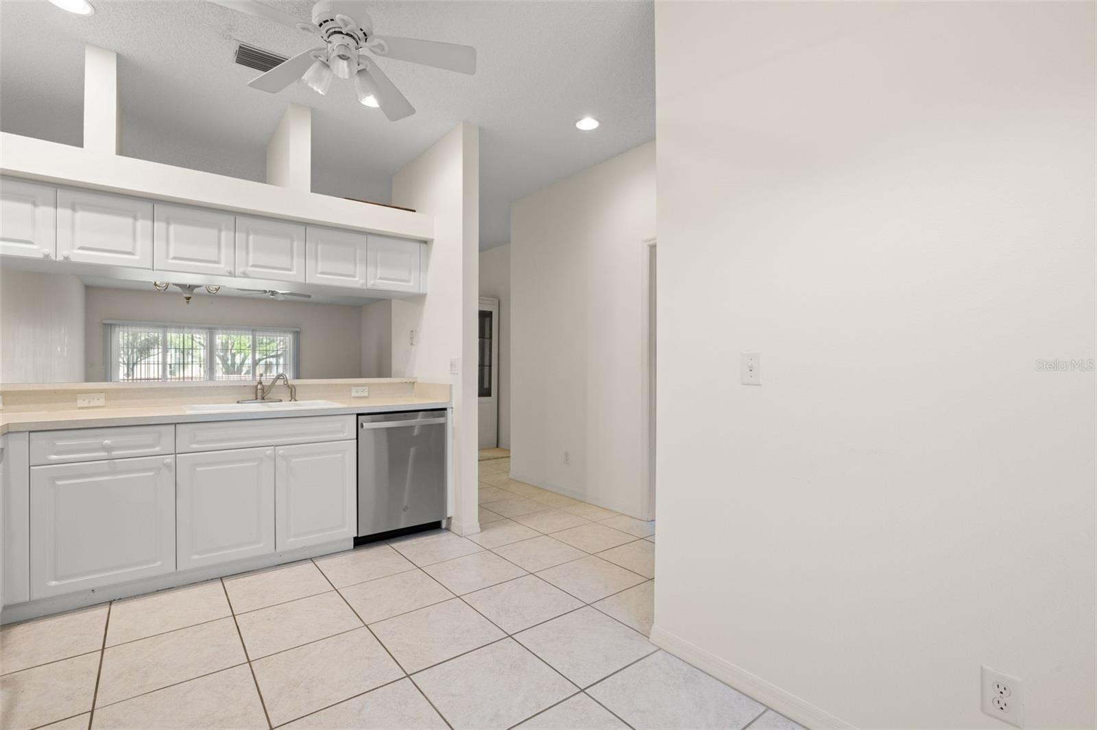 Kitchen highlighted by vaulted ceilings and an upper display ledge, adding architectural interest and a sense of openness to the space.