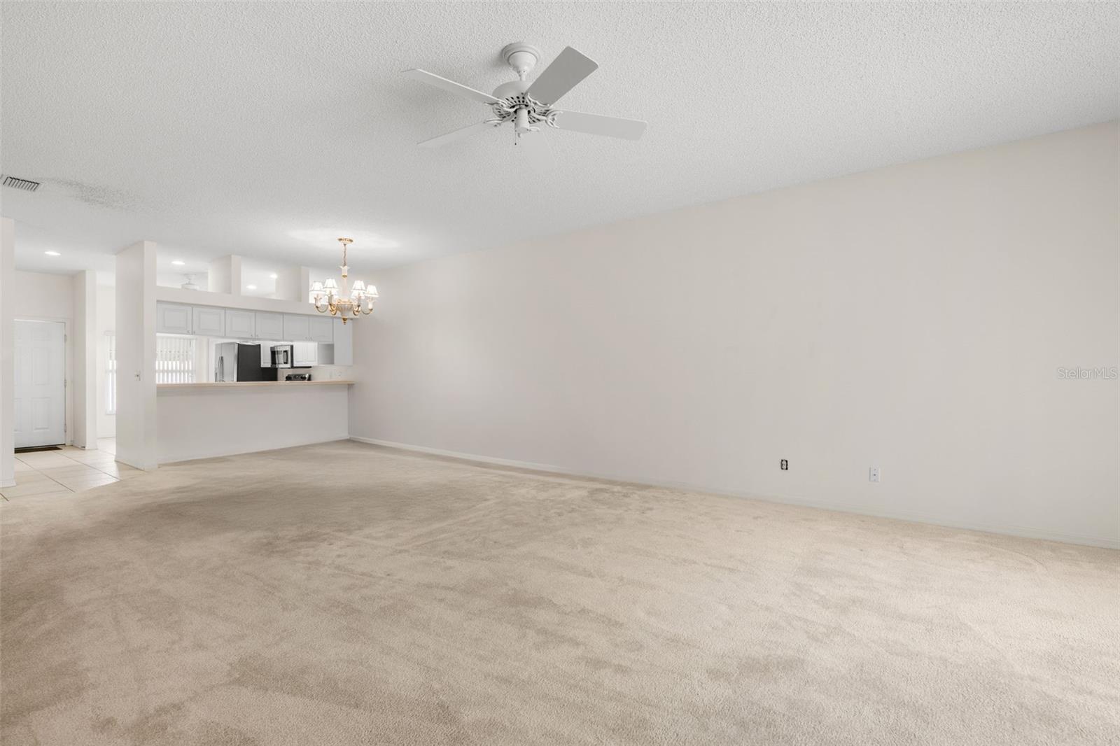 Expansive living room with generous proportions and a versatile layout that easily accommodates multiple seating arrangements or a combined living and workspace setup.