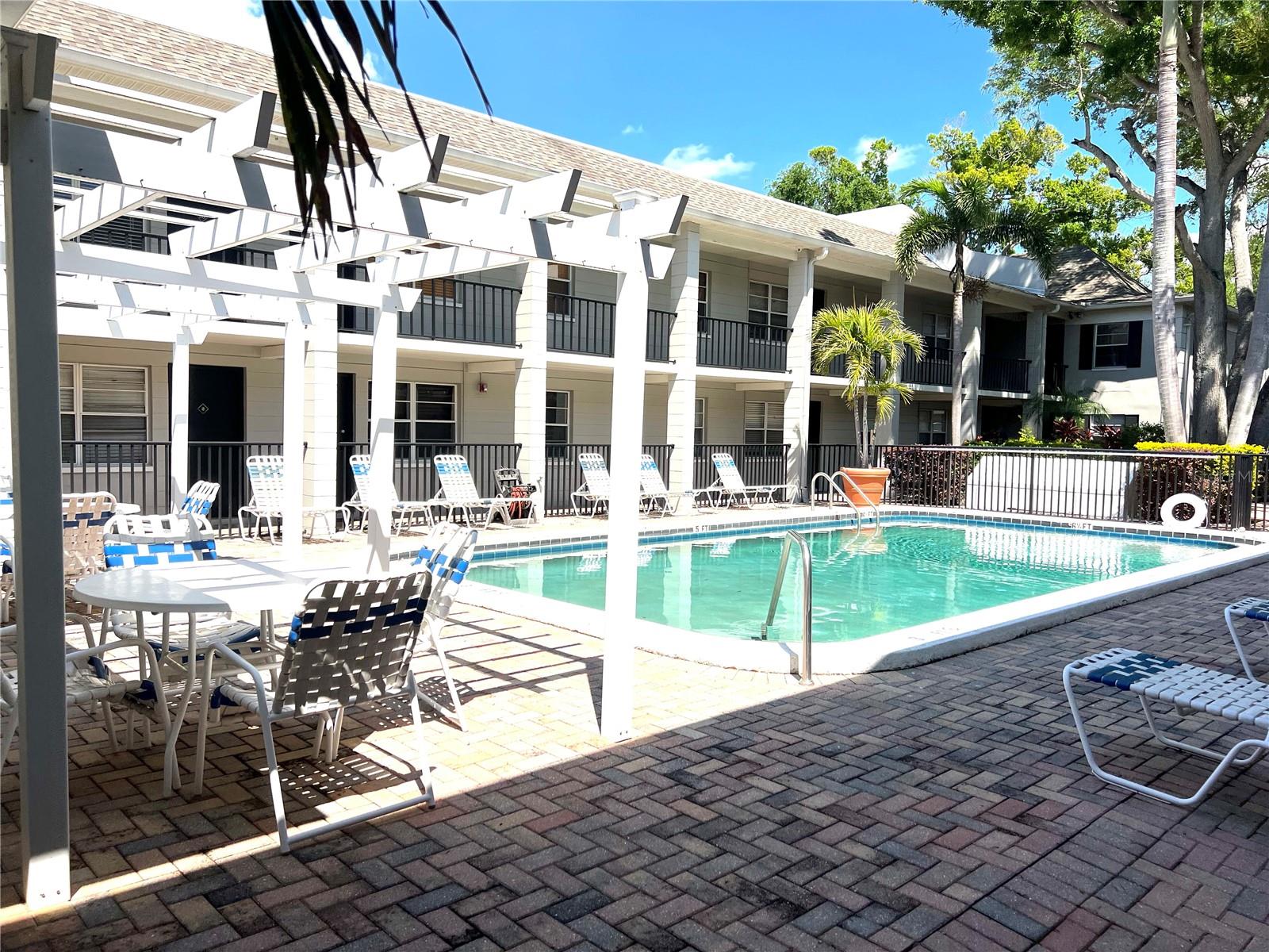 Pool area with loungers and seating for working at home or taking a break.