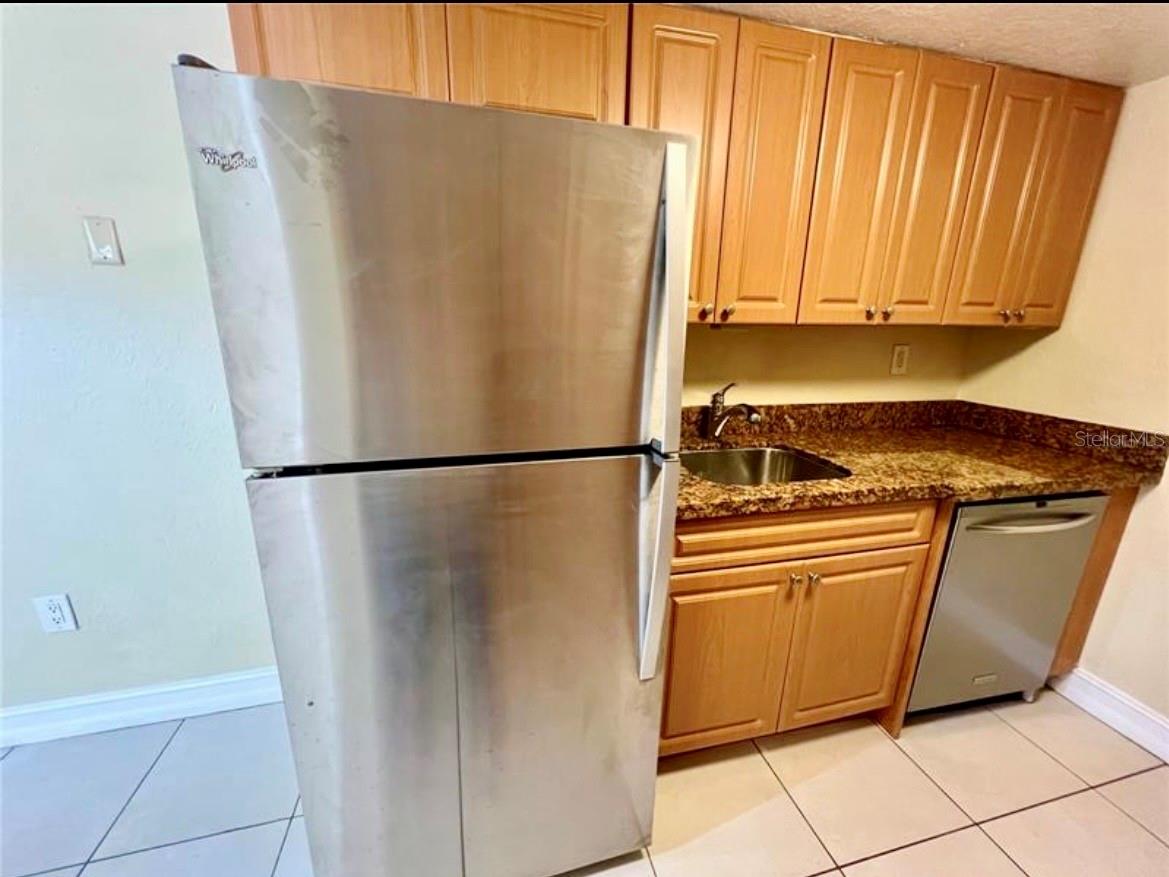 The kitchen is complete with stainless steel appliances and granite countertops.
