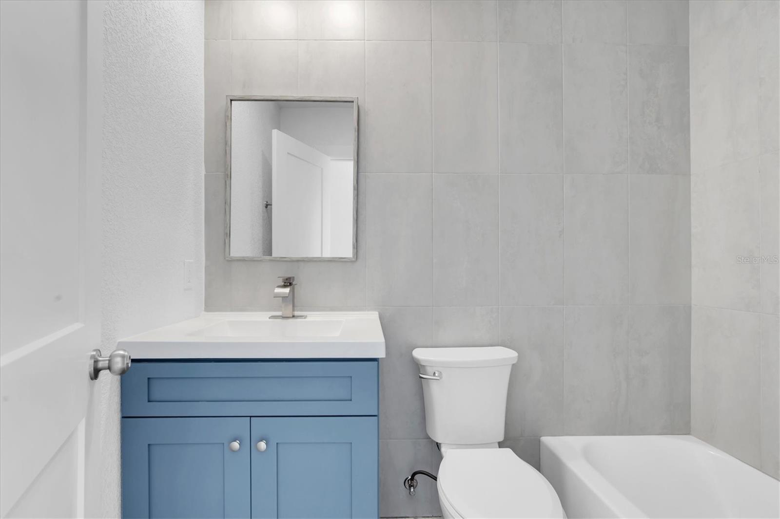Newly remodeled Tiled Bathroom with tub shower combo, new vanity, fixtures, new from floor to ceiling - Right Side