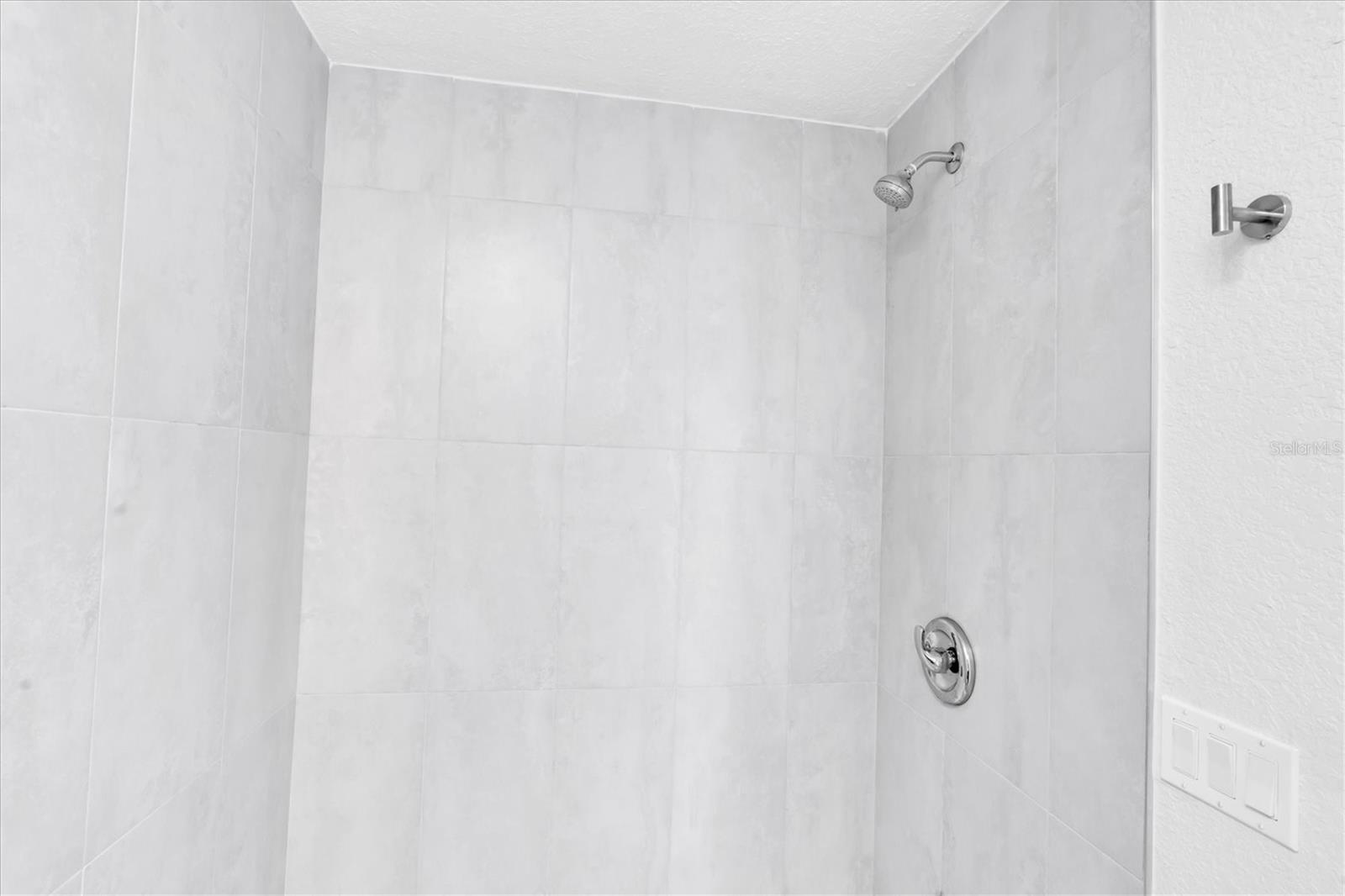 Newly remodeled Tiled Bathroom with tub shower combo