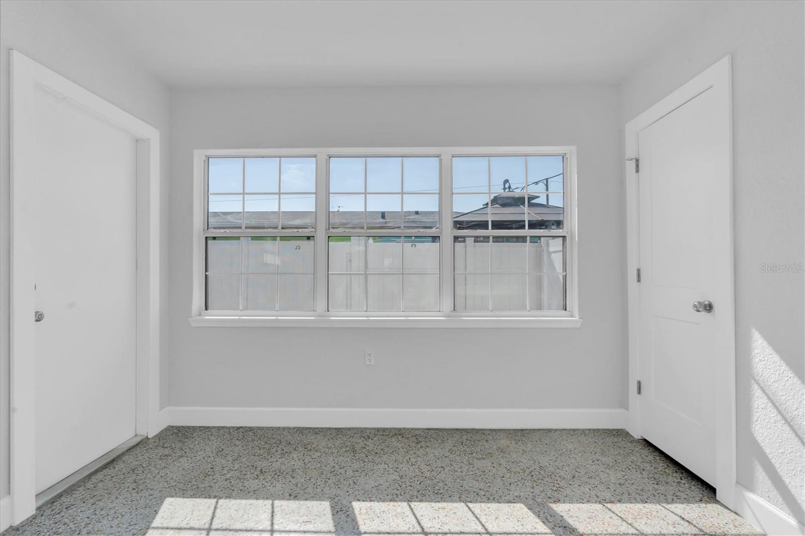 Bedroom 2 with lots of windows, a closet, and Window unit- Left Side