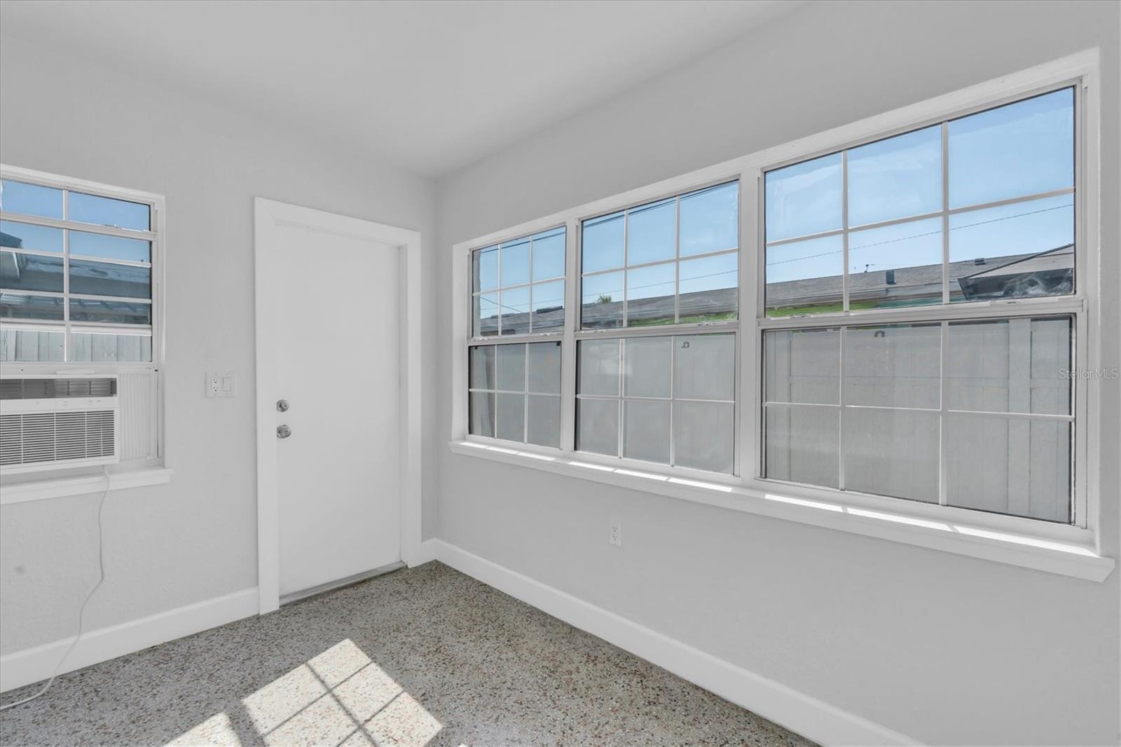 Bedroom 2 with lots of windows, a closet, and Window unit- Left Side