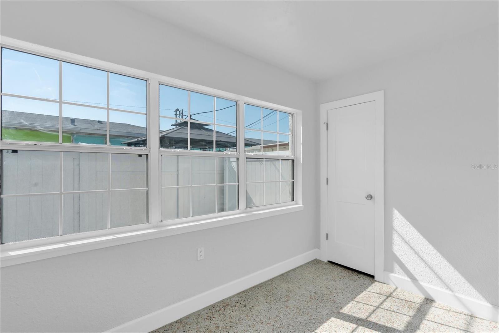 Bedroom 2 with lots of windows, a closet, and Window unit- Left Side