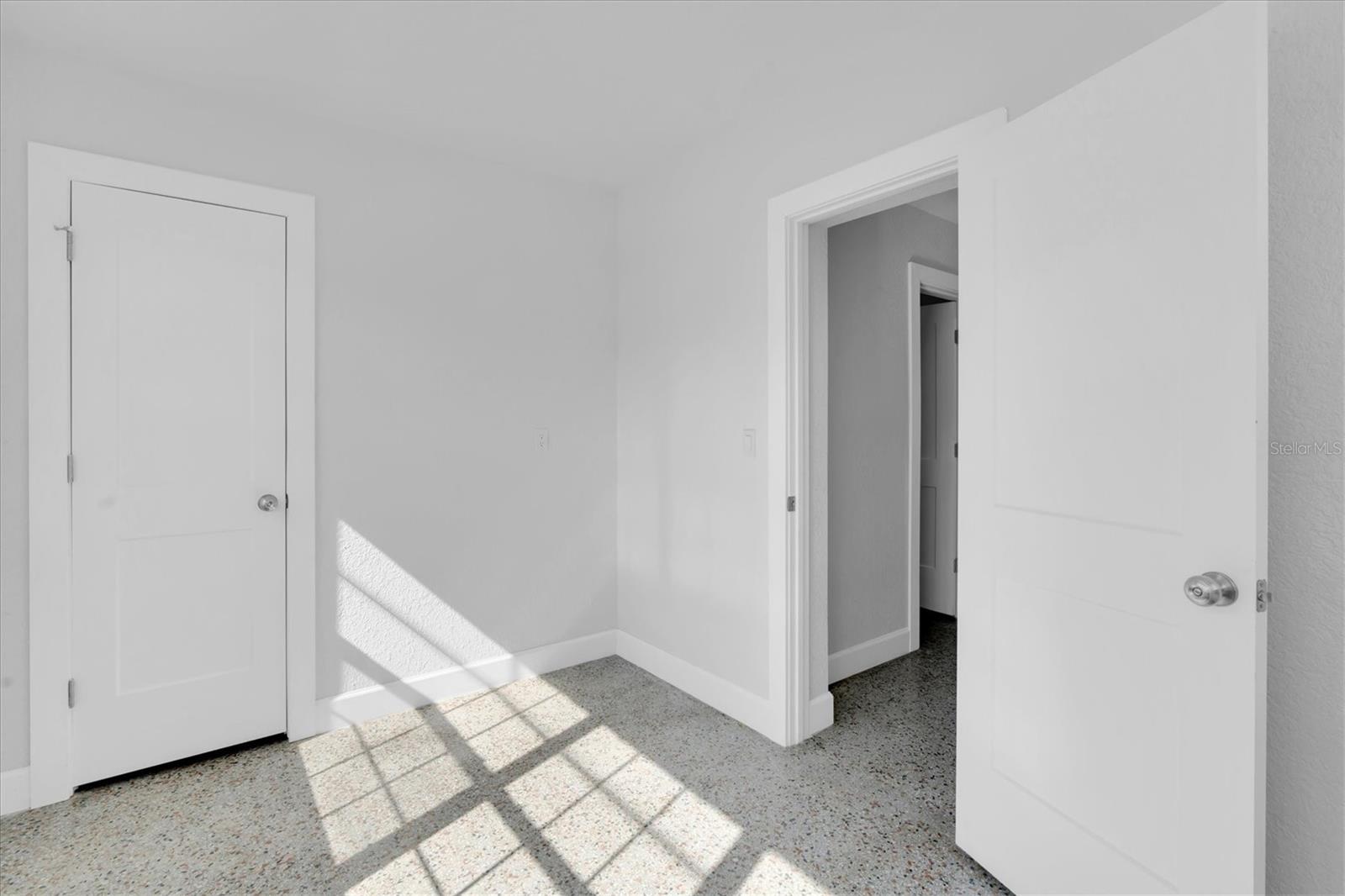 Bedroom 2 with lots of windows, a closet, and Window unit- Left Side