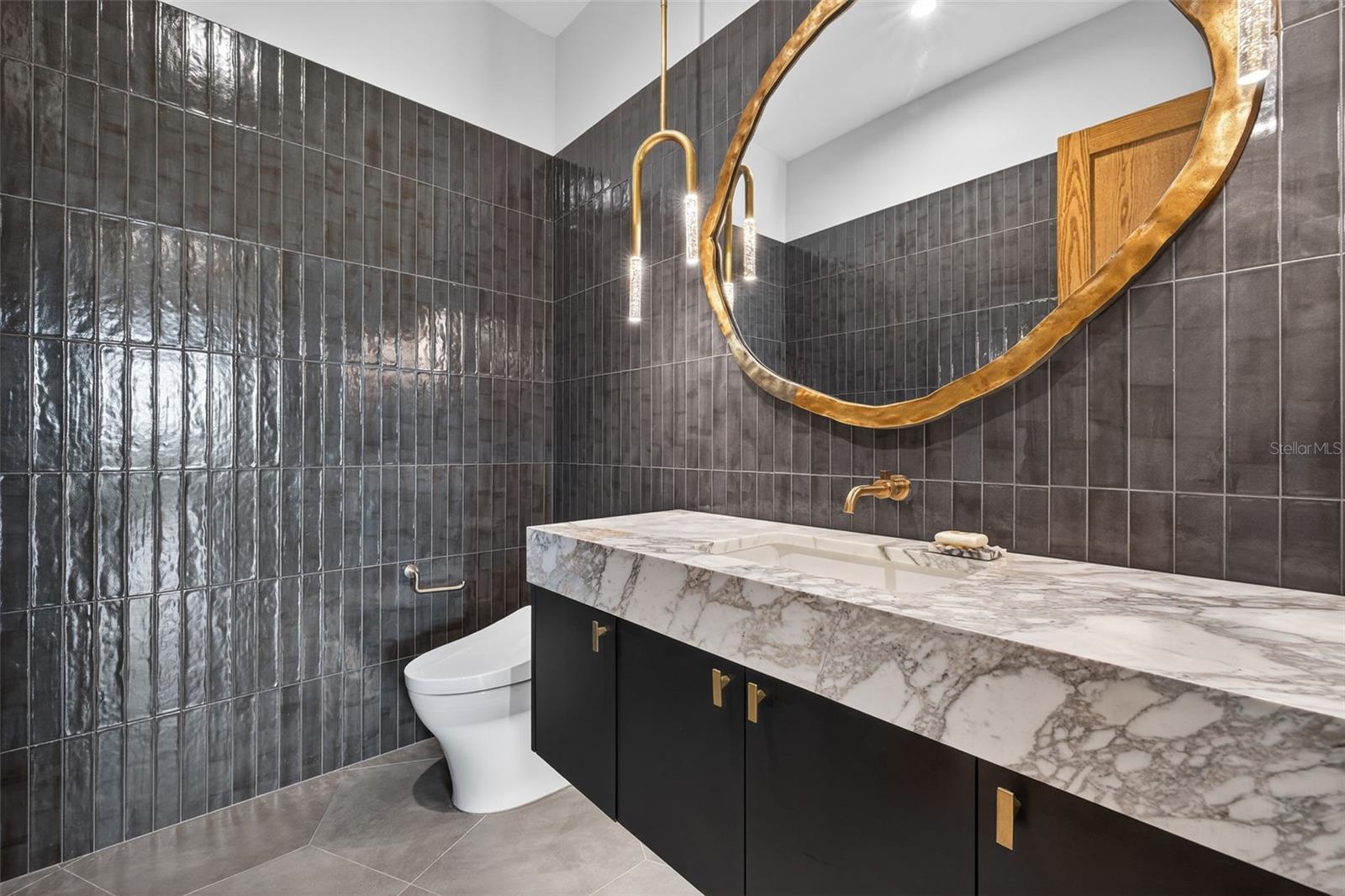 Downstairs guest powder bathroom. Kelly Wearstler light fixture
