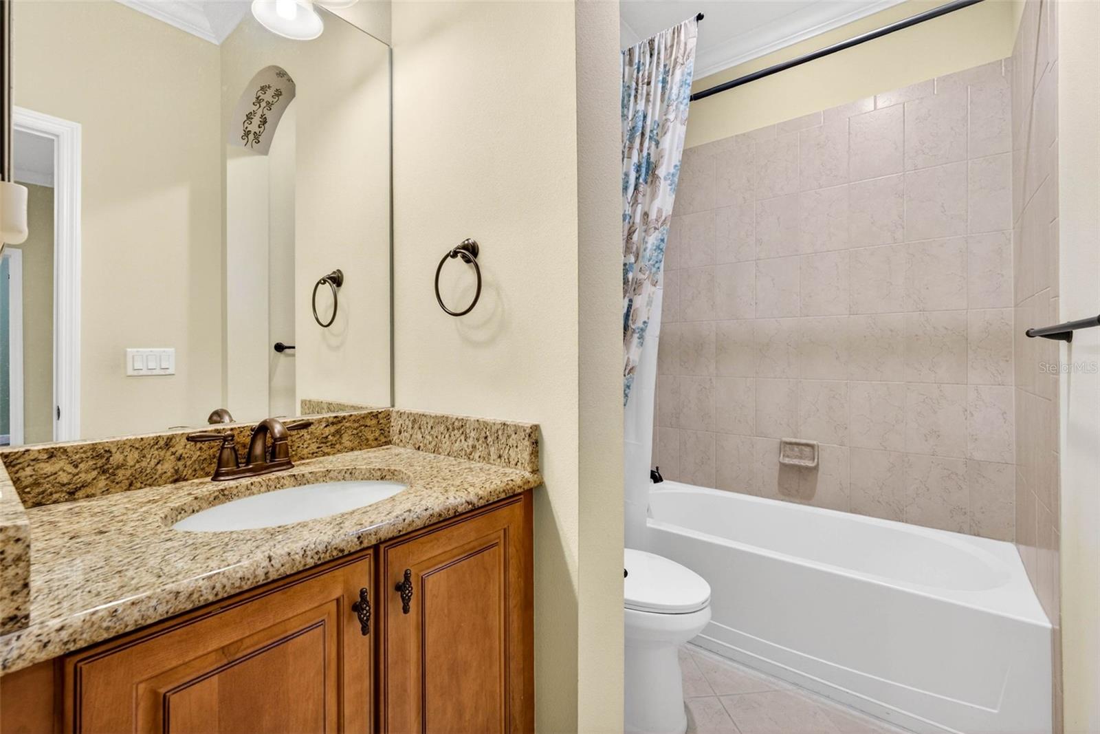 Secondary bathroom with comfort height vanity and shower/tub combination.