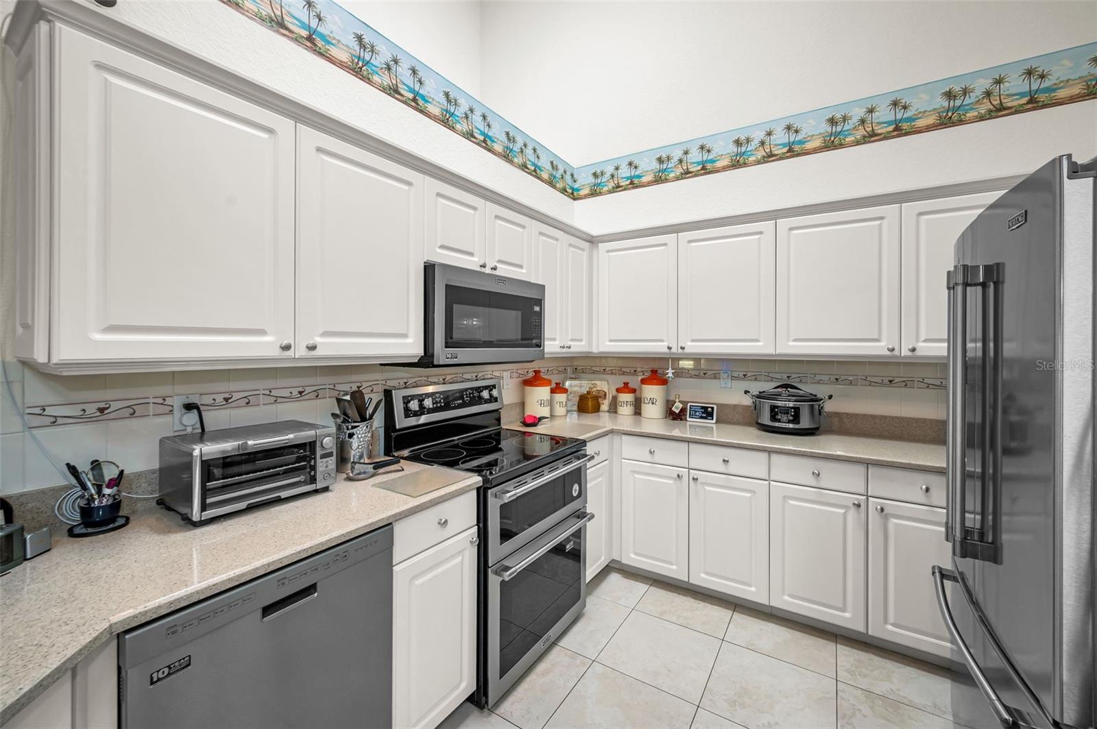 Gleaming white kitchen cabinets and Stainless steel appliances