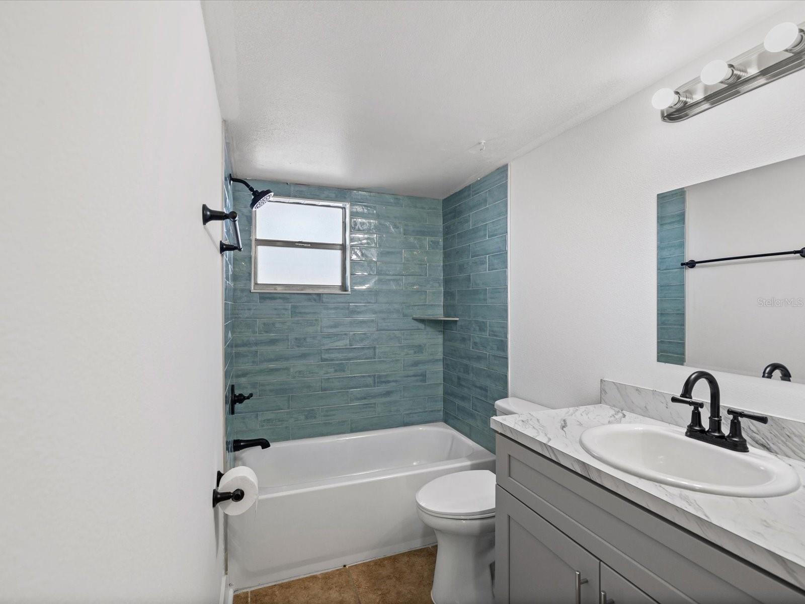 NEW FIXTURES AND TILED TUB WALL