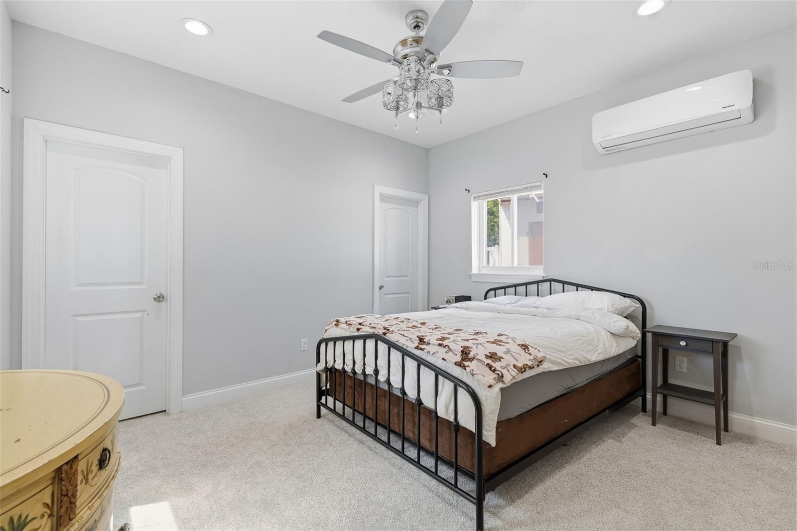 Spacious primary bedroom with natural light
