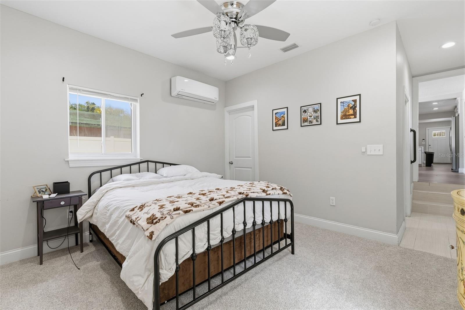 Primary bedroom with clean, neutral finishes