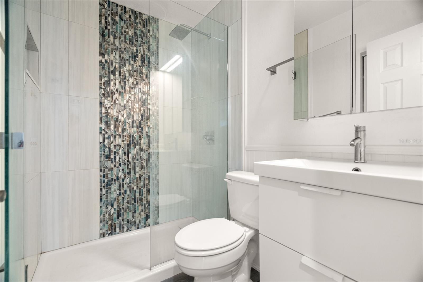 Stylish bathroom with walk in shower.