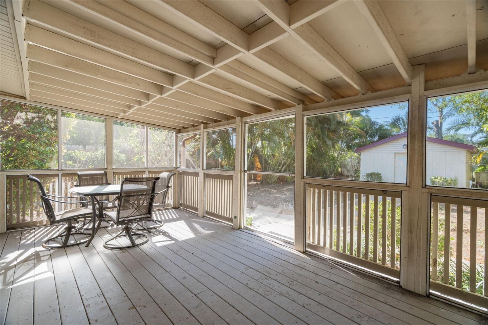 Life extends outdoors with a screened Florida room.