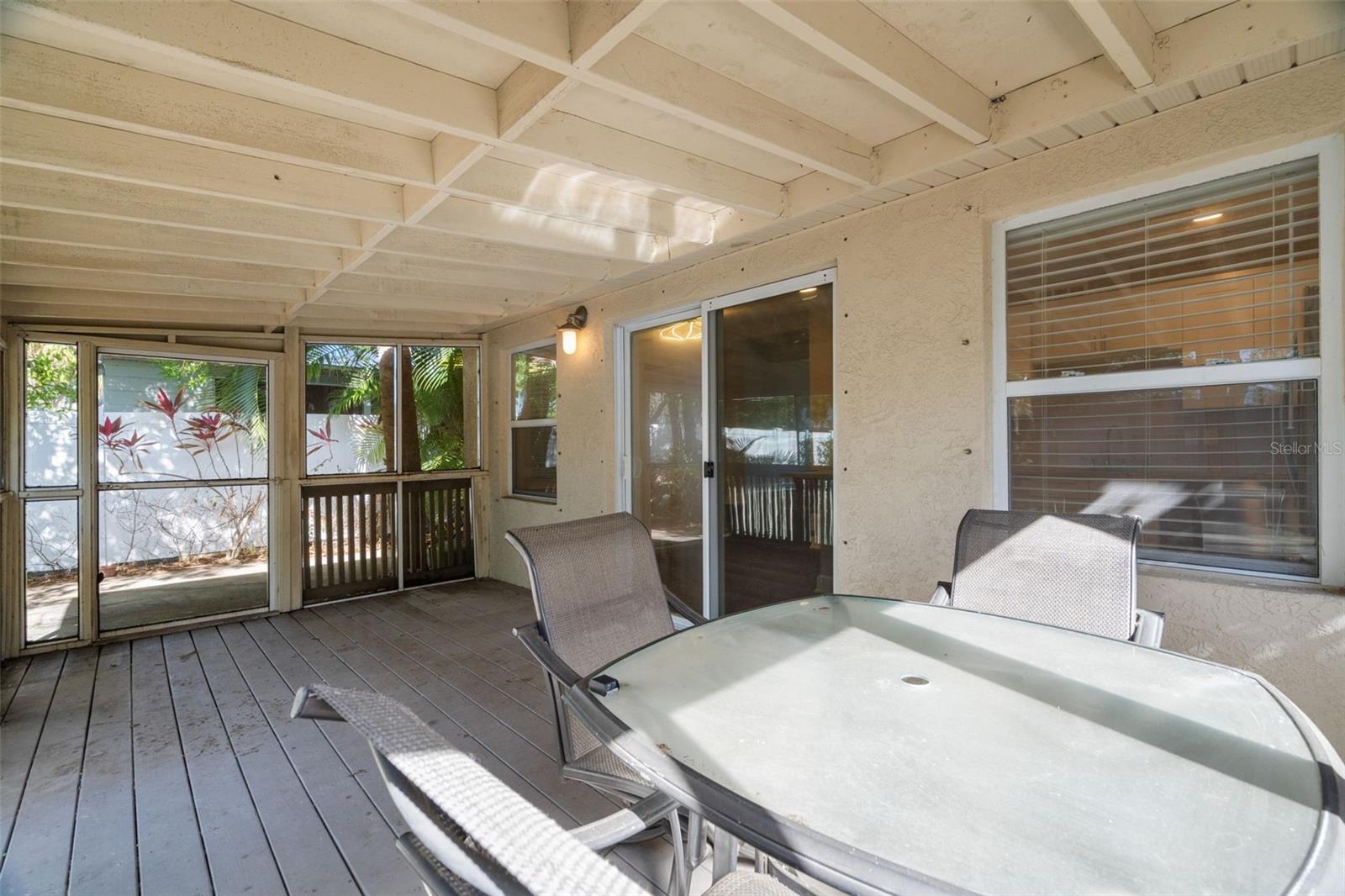 Life extends outdoors with a screened Florida room.