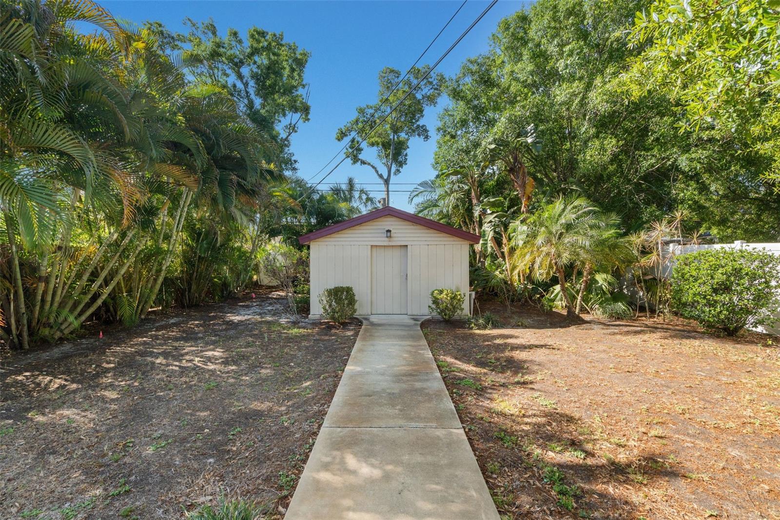 An accessory building adds versatility, ideal for storage, an art studio, or future workshop.