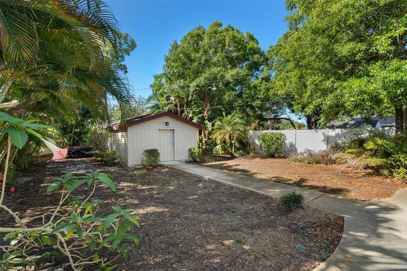 The landscaping has been carefully designed to create a private, tropical setting