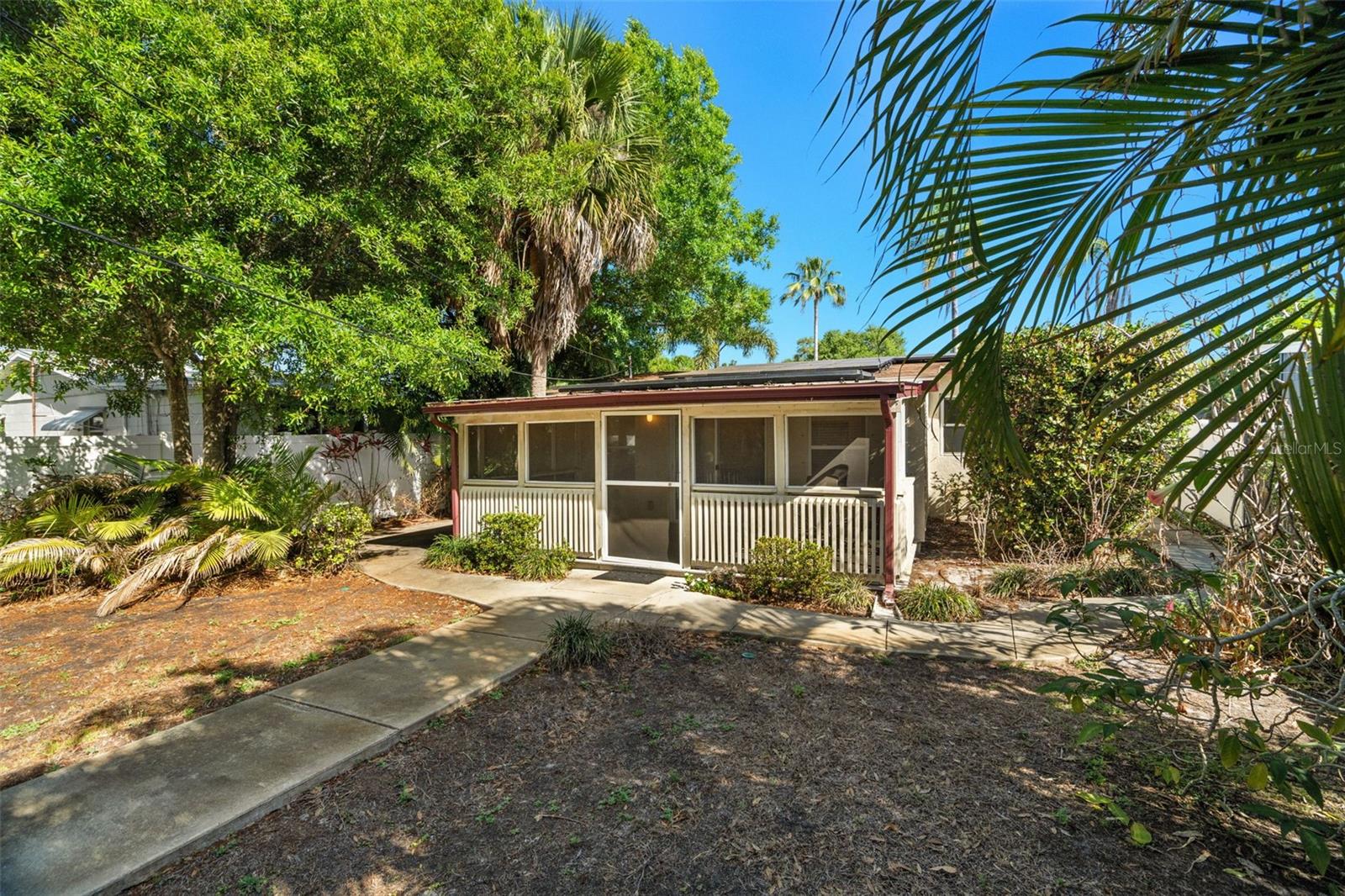 The landscaping has been carefully designed to create a private, tropical setting