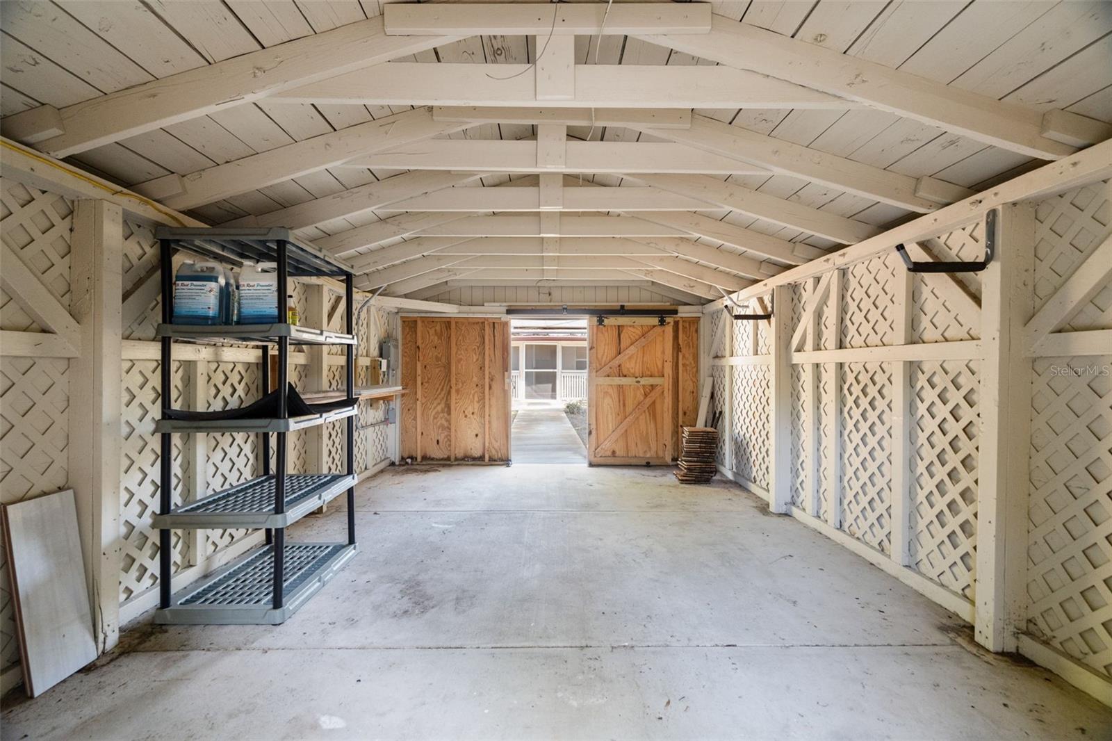 An accessory building adds versatility, ideal for storage, an art studio, or future workshop.