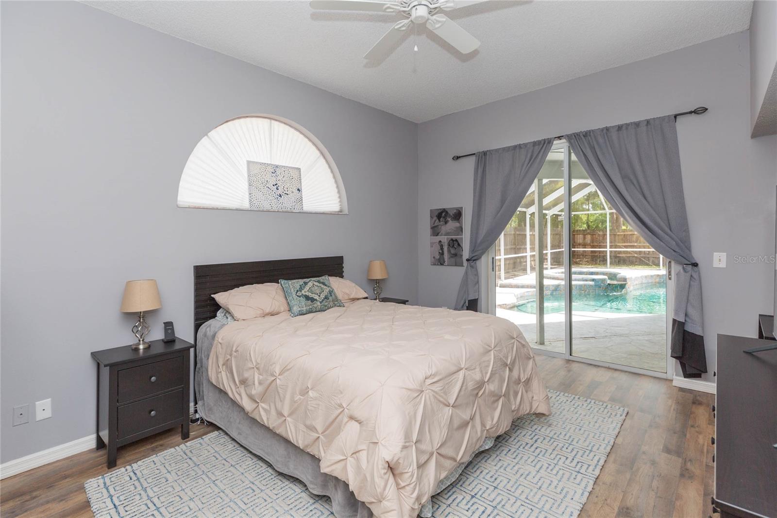 Primary bedroom with double sliders to the pool and spa