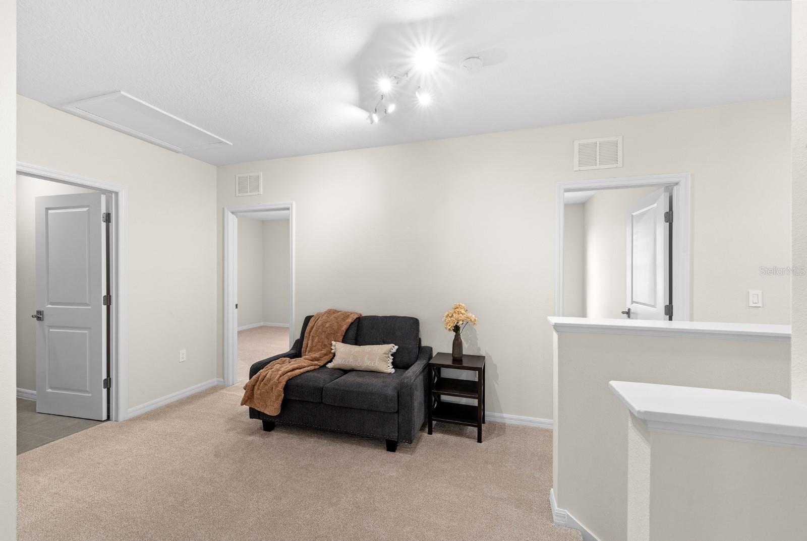 At the top of the stairs is the loft which can accommodate a couch, a desk, or even a large LoveSac beanbag!