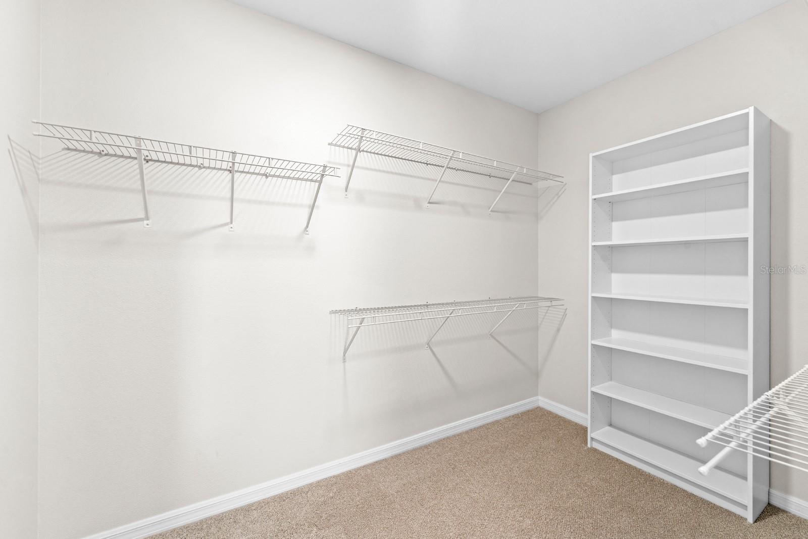 The Primary Walk-in Closet features custom shelving and a full length wall mirror (see 3D tour)
