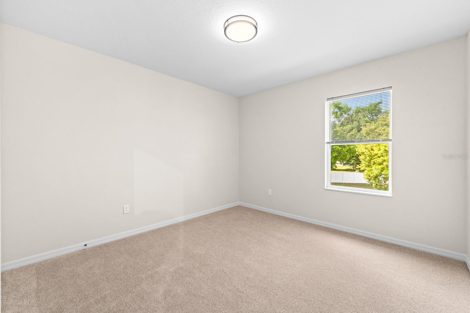 Bedroom 2 has new carpet, window blinds, and lighting.