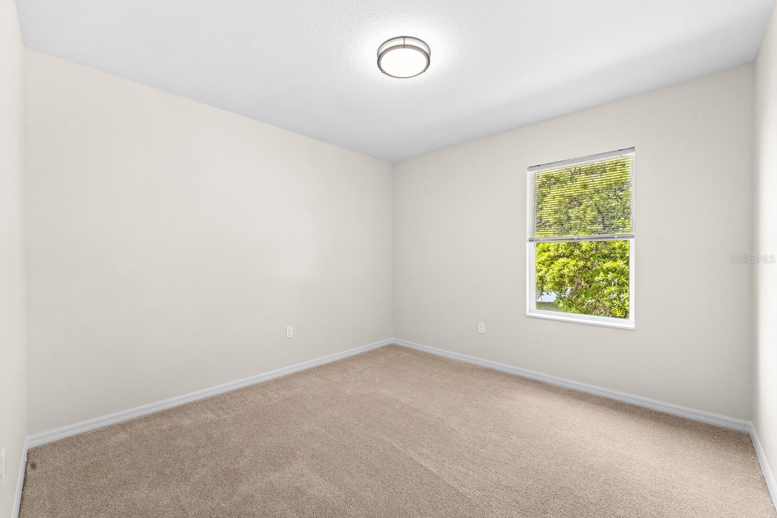 Bedroom 3 has new carpet, window blinds, and lighting.