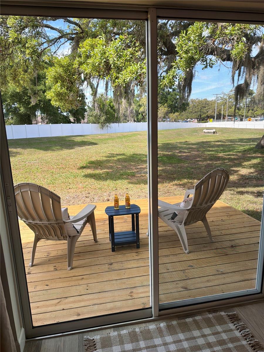 Sit and enjoy a chilled beverage on your new back patio.  It can easily be screened in if desired.