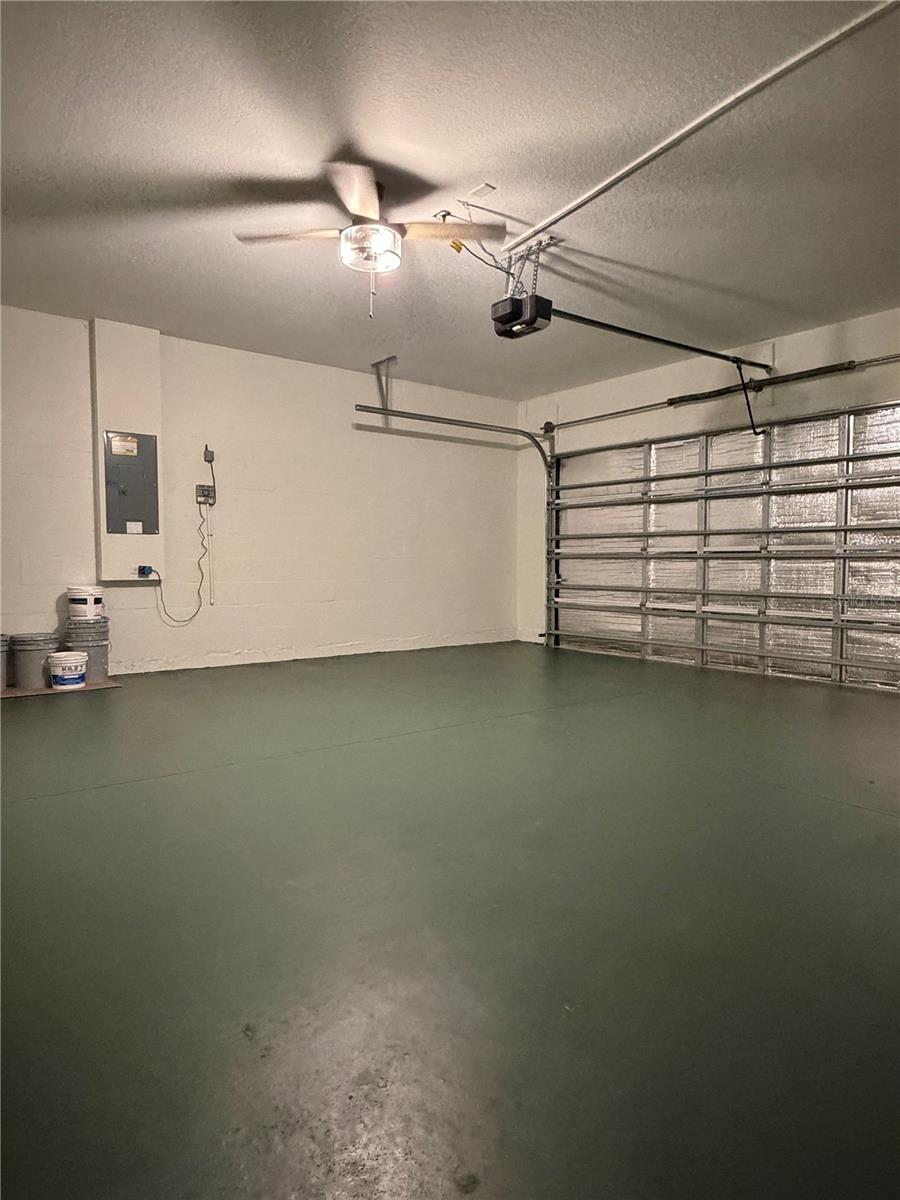There's a ceiling fan in the garage, and the concrete floor was painted a deep emerald green.  The garage door opener is brand new.