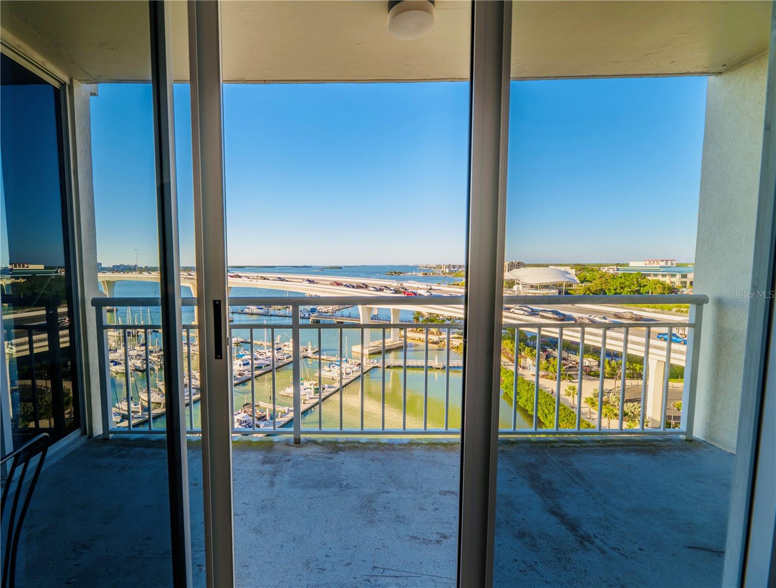 Hurricane proof sliding glass doors onto balcony from Primary Bedroom