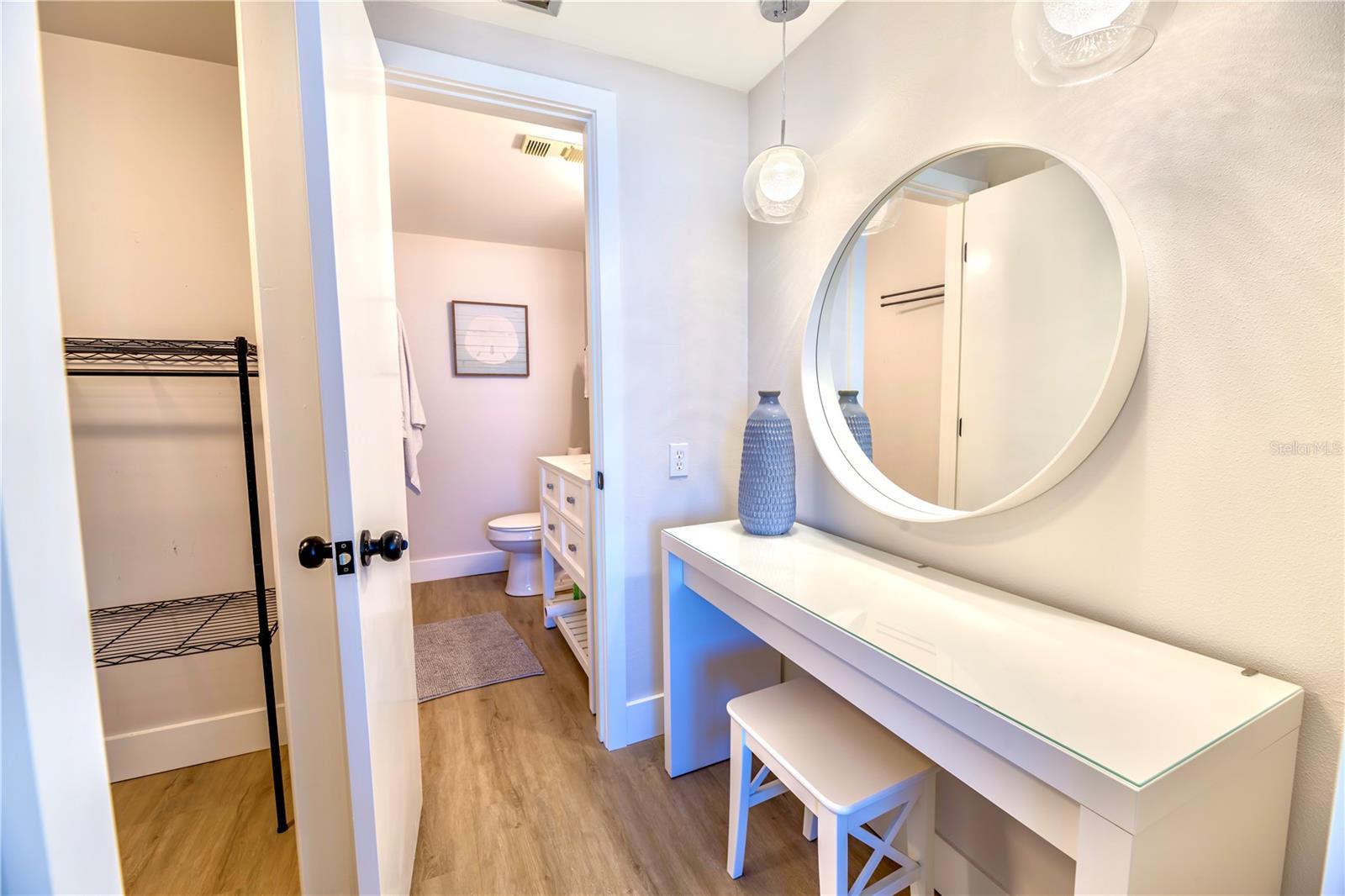 Left - door from Master Closet into Separate Vanity Area then into Primary Bathroom with Shower