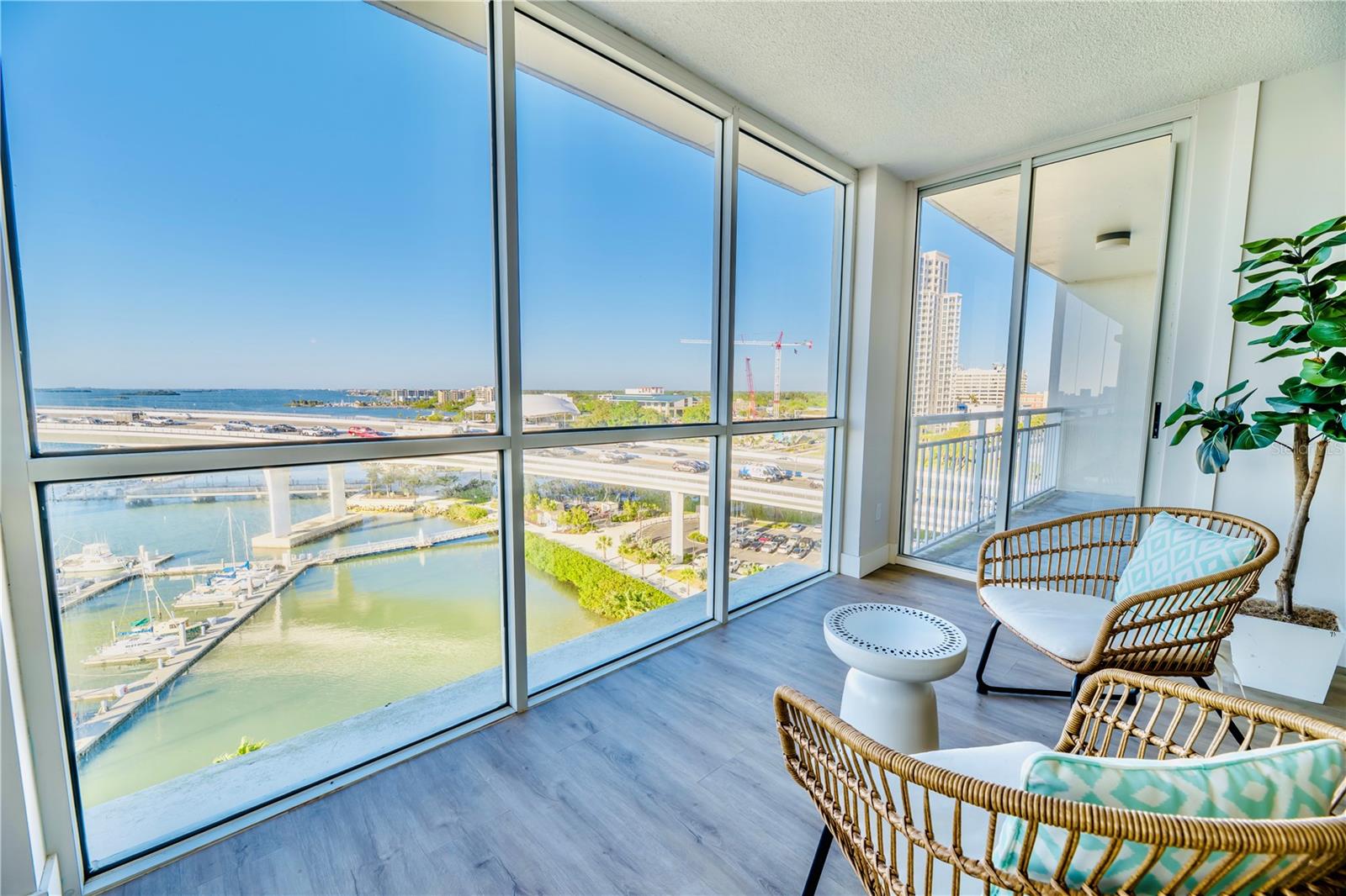 Left to Right:  Floor-to-Ceiling Windows in Living Room into Balcony of Bedroom 2