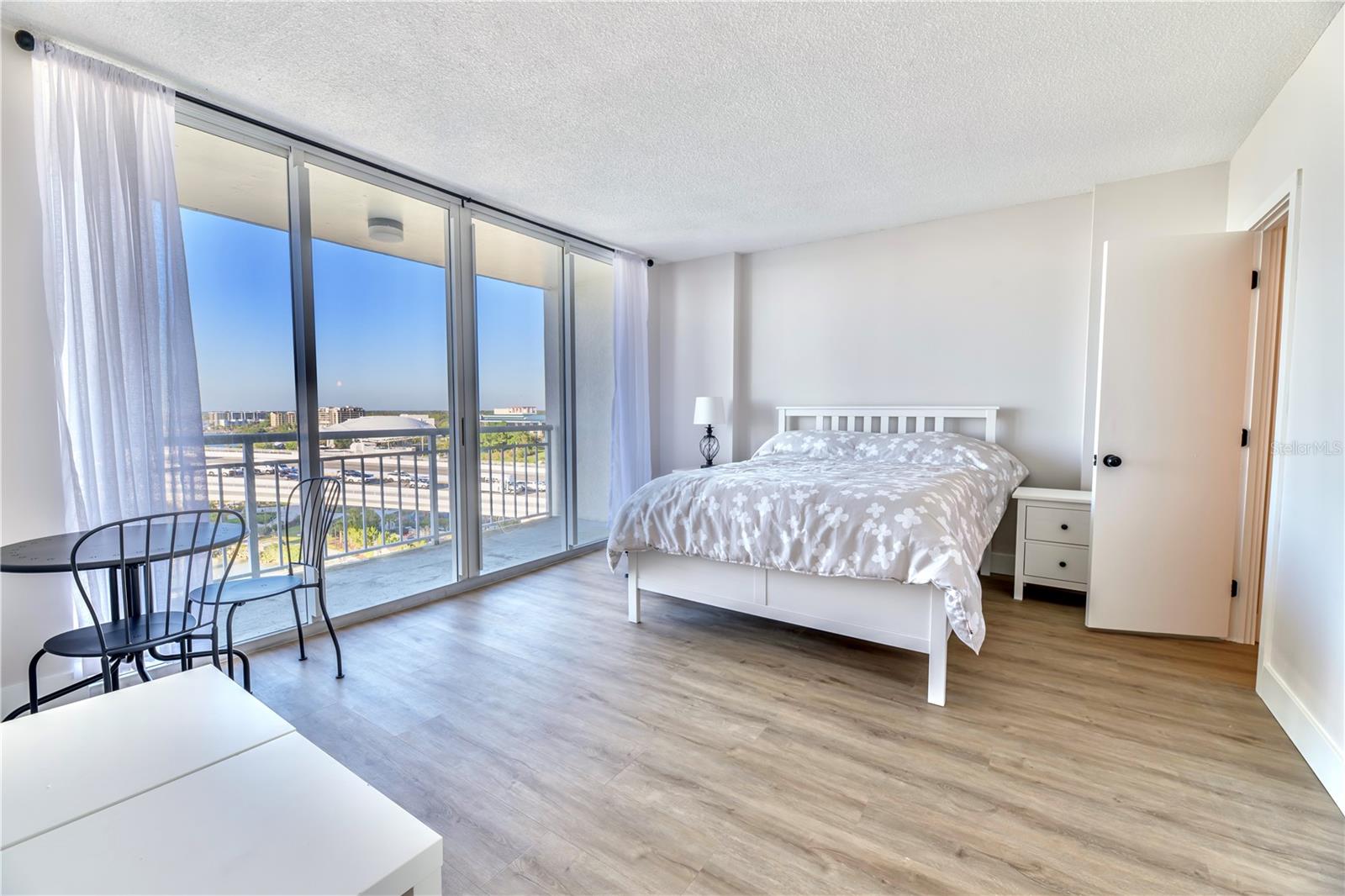 2nd bedroom with private balcony and entry into bathroom