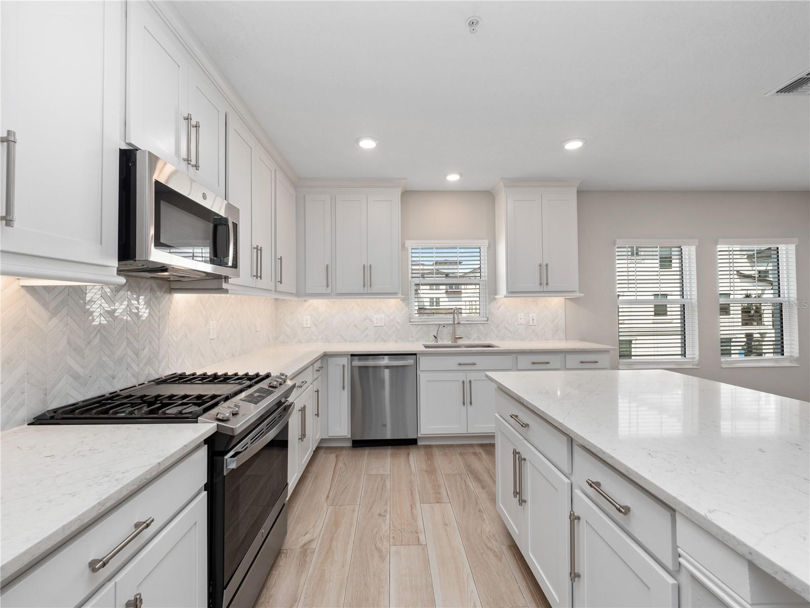 high end appliances, granite counter tops, marble backsplash and Views of the bay from the dining room and kitchen