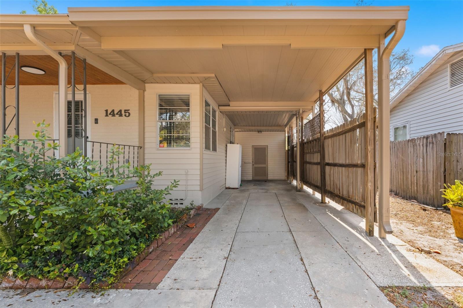 Covered carport parking with additional storage space in back