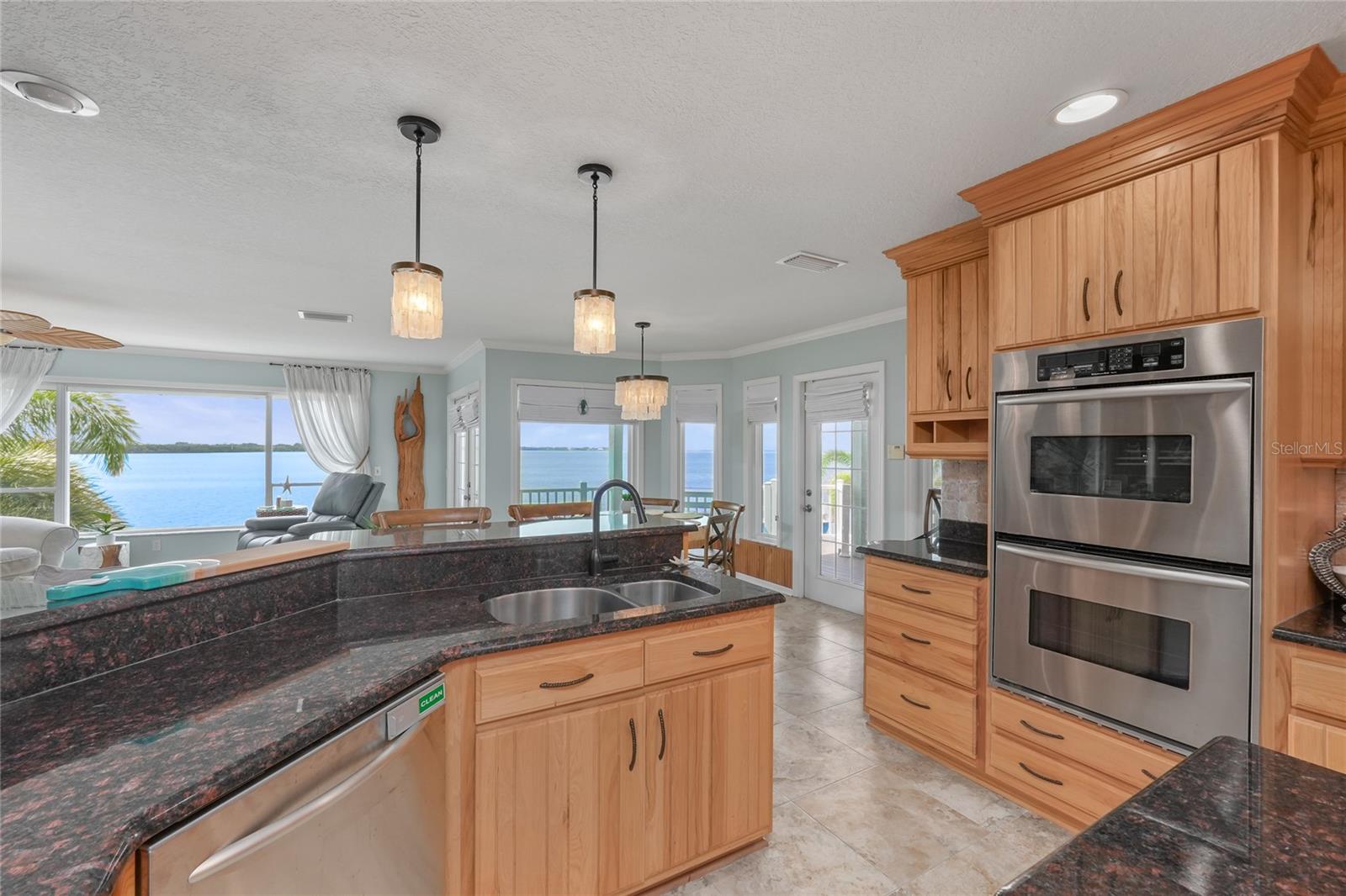 Well-appointed kitchen with seamless flow to main living areas and water views