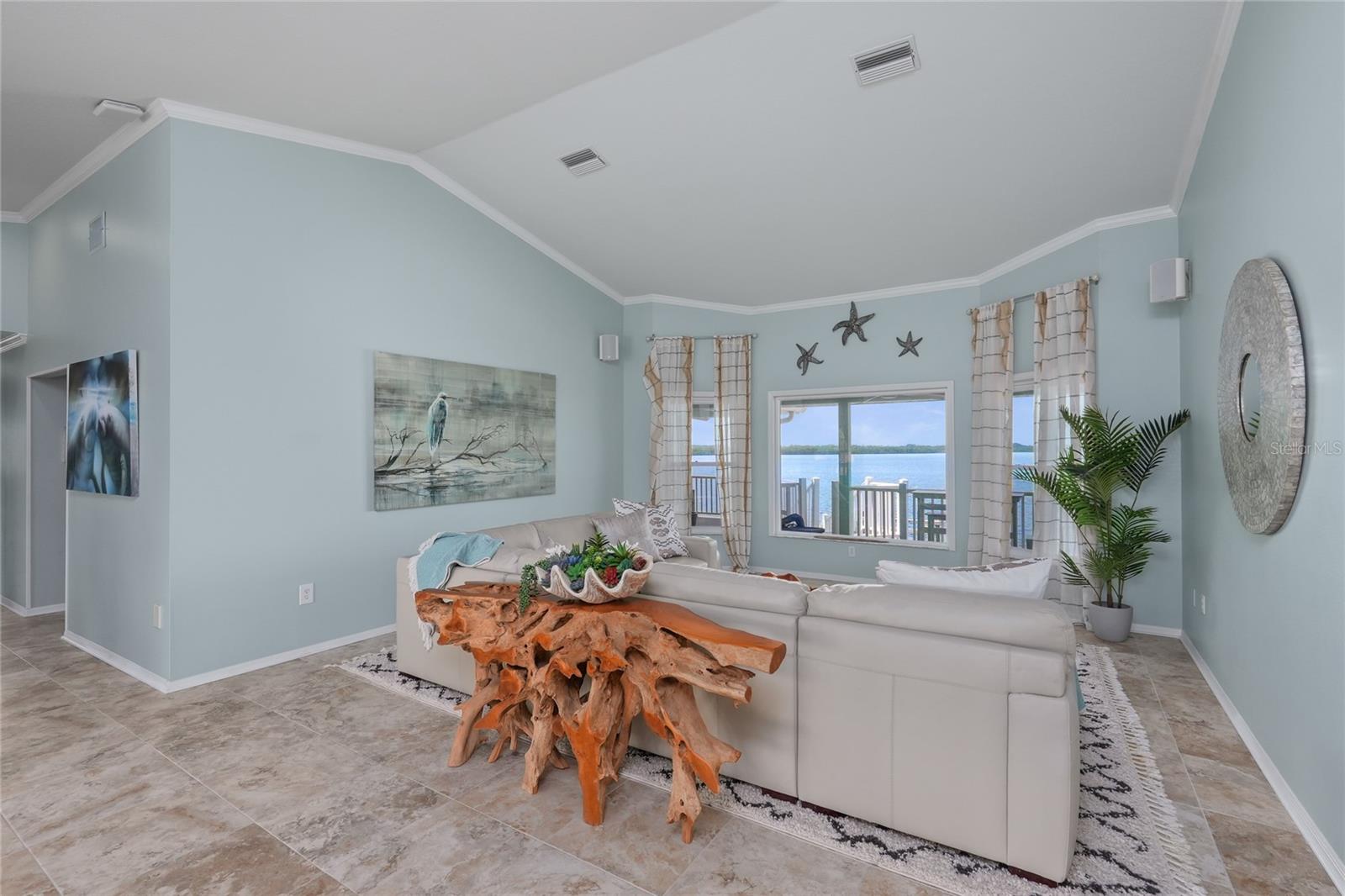 First impression—step inside and take in sweeping water views throughout the home
