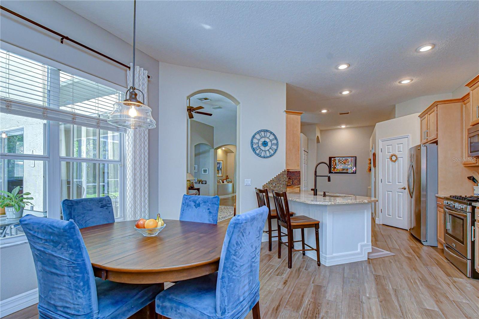 Bright, casual dining space overlooking the pool and backyard