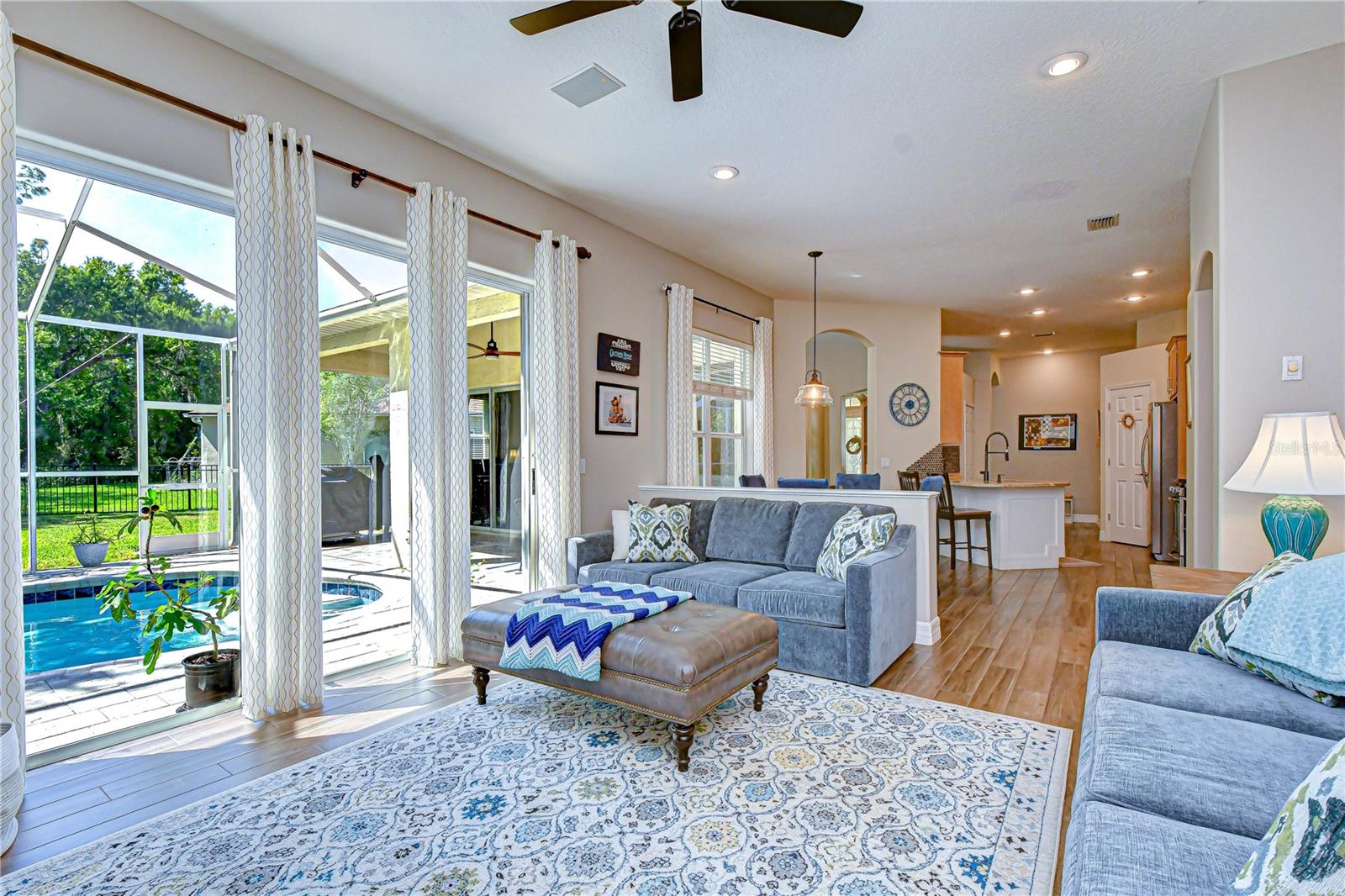 Open-concept layout connecting living, kitchen, and outdoor spaces