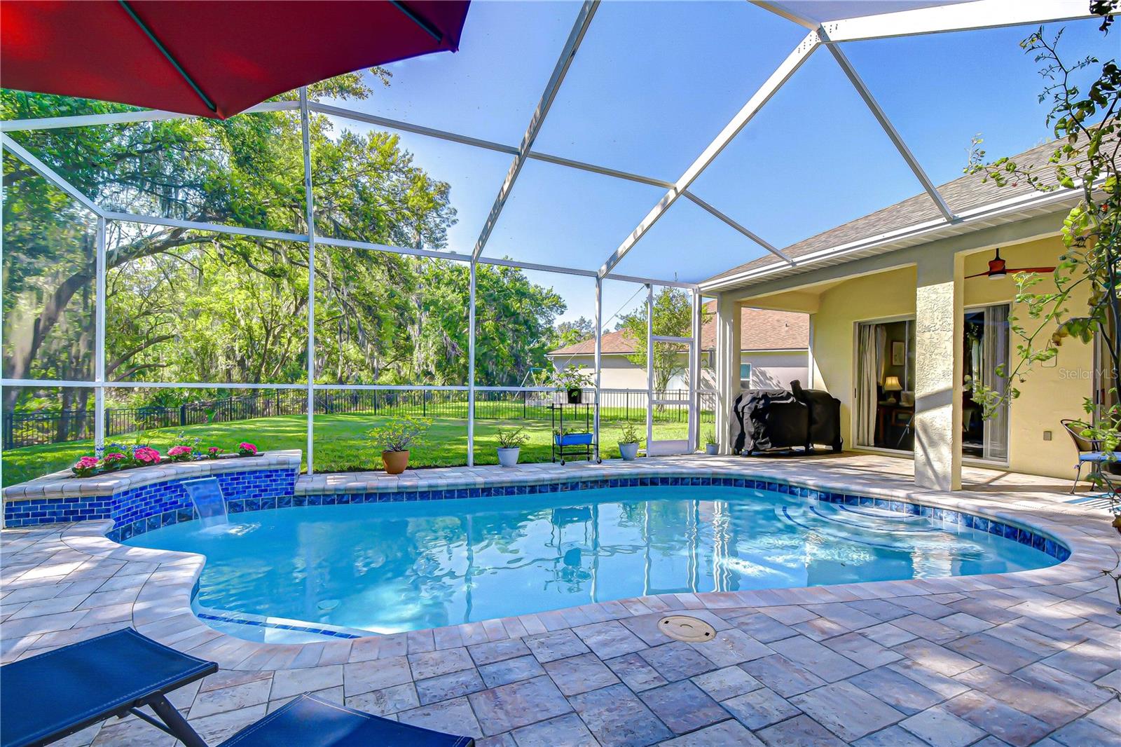 Relax poolside with tranquil views and no rear neighbors