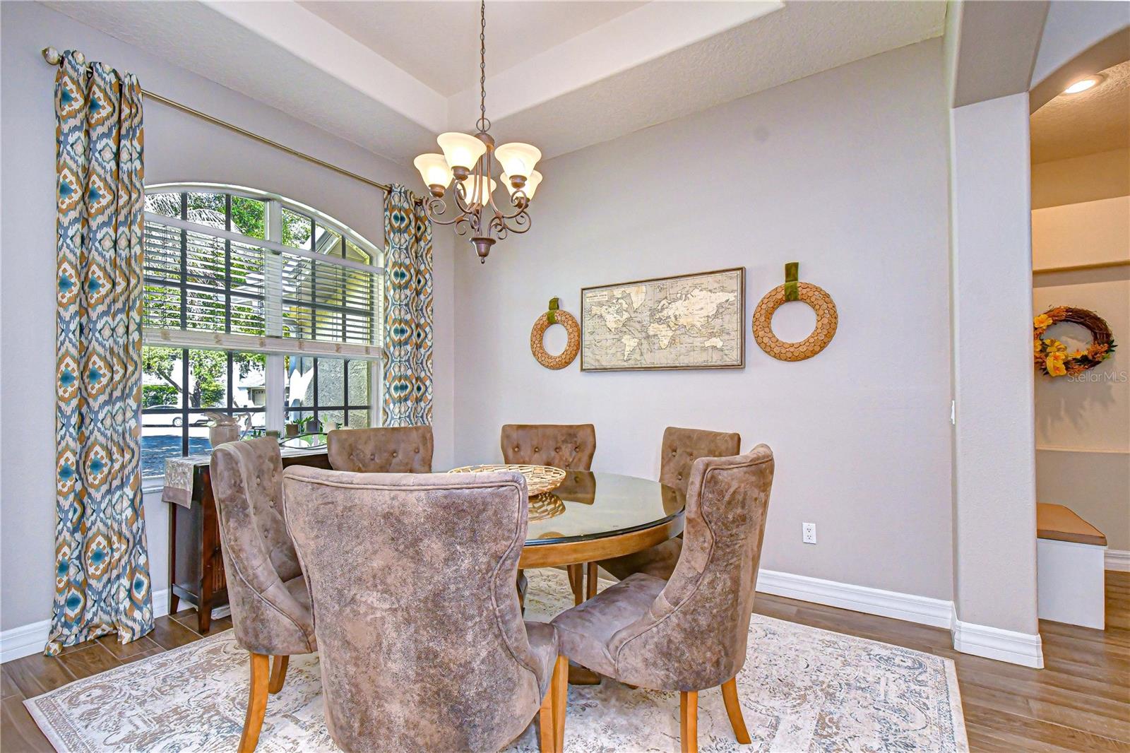Elegant gathering space featuring tray ceilings and refined architectural detail