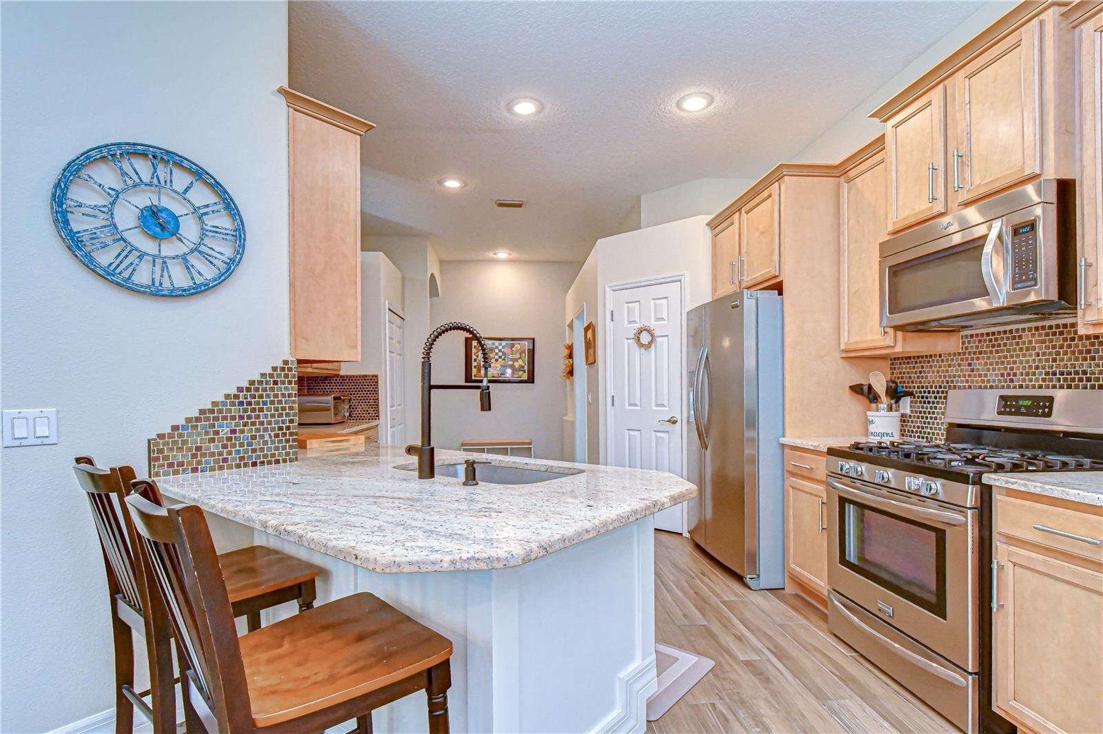 Well-appointed kitchen featuring rich cabinetry and a warm, inviting design